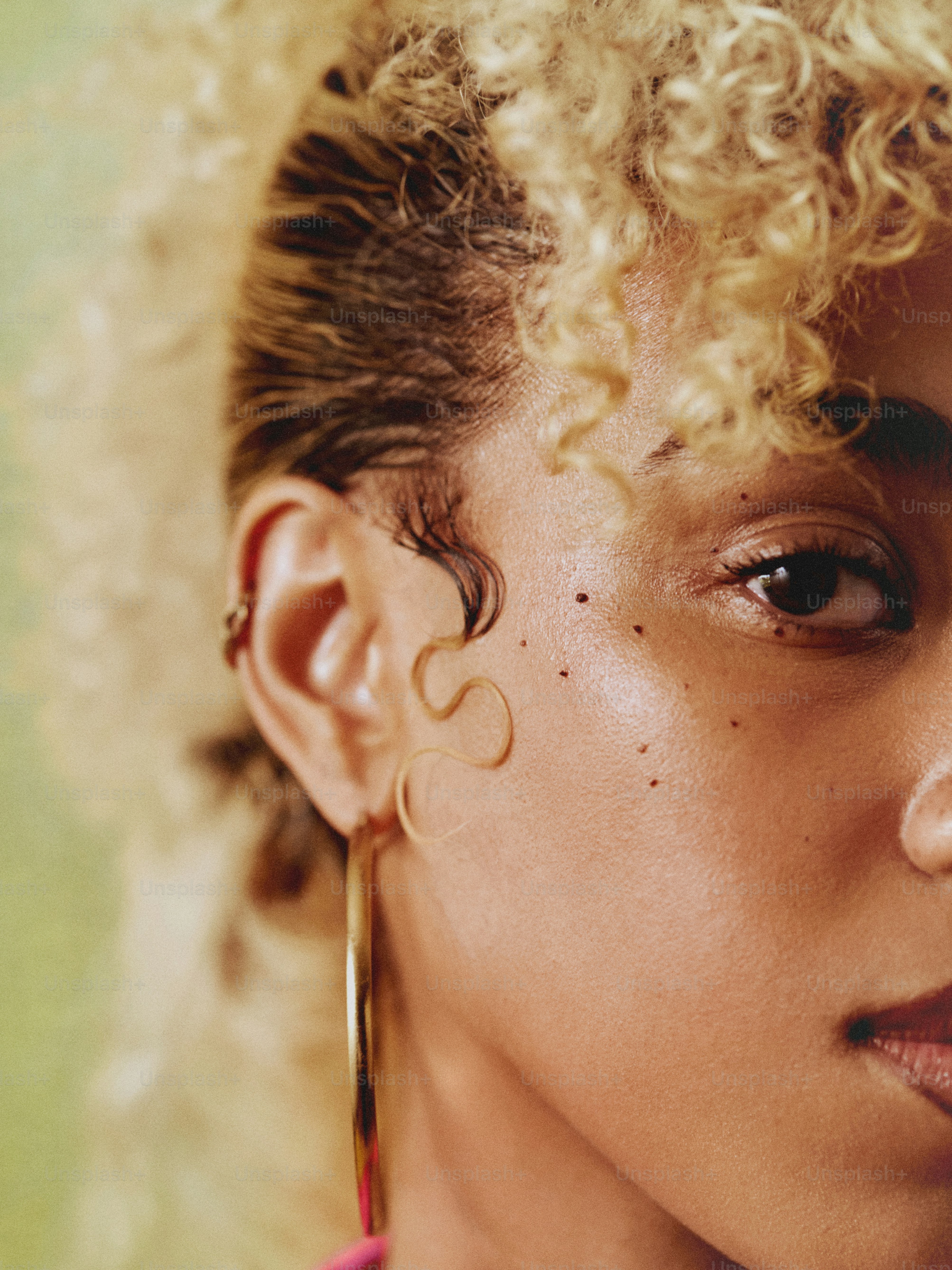 a close up of a person with curly hair