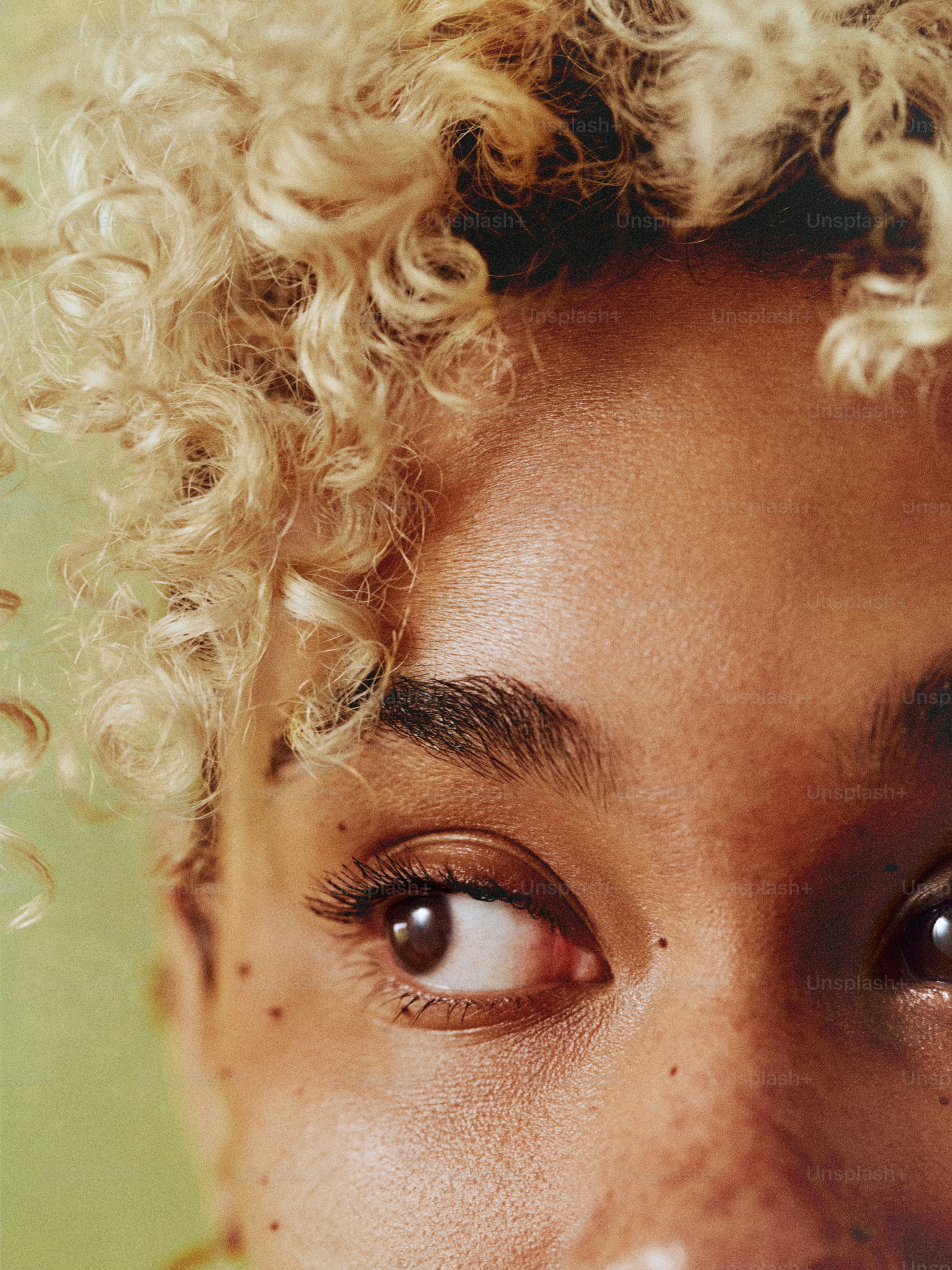 a close up of a person with curly hair