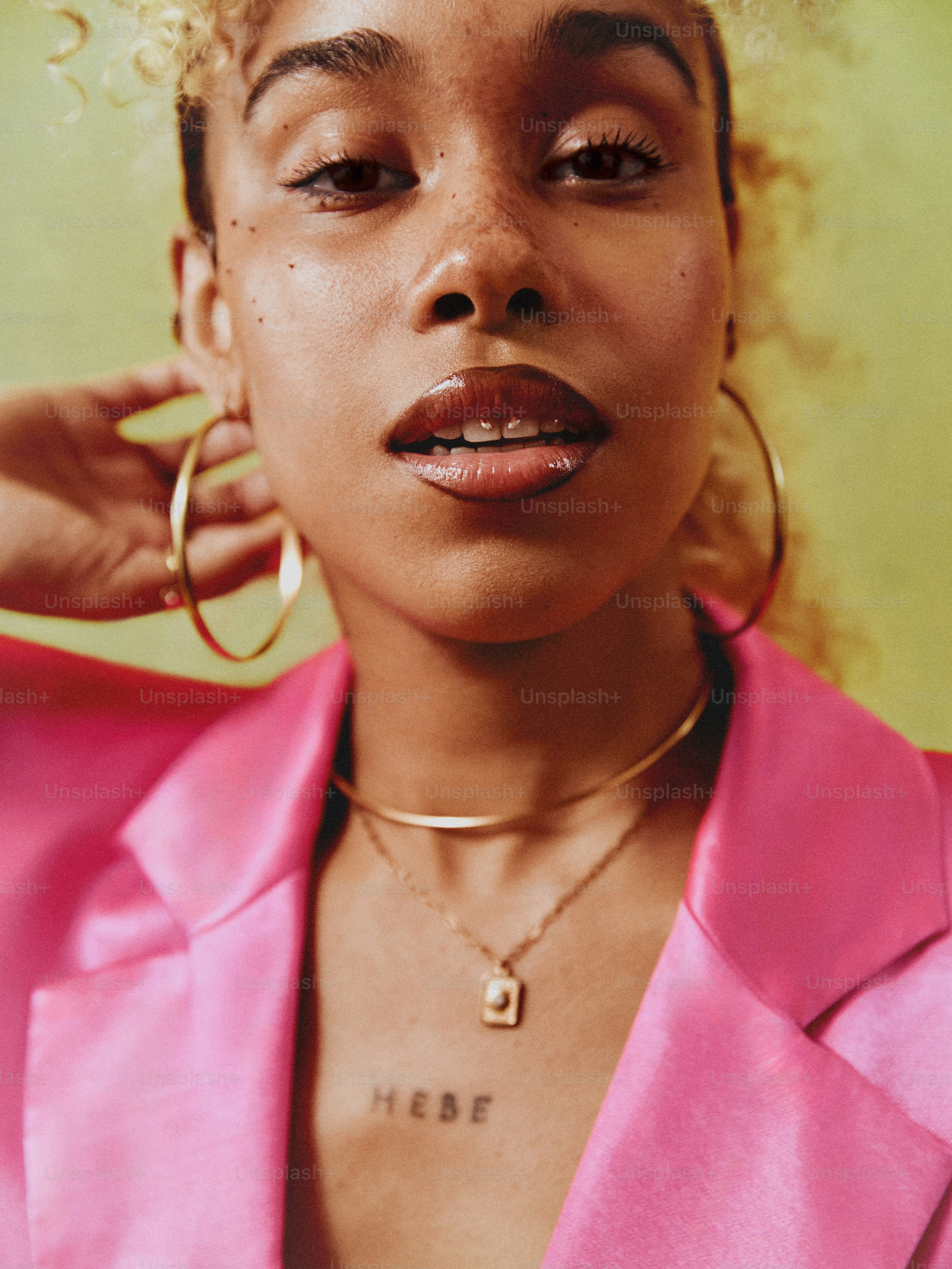 a close up of a person wearing a pink shirt