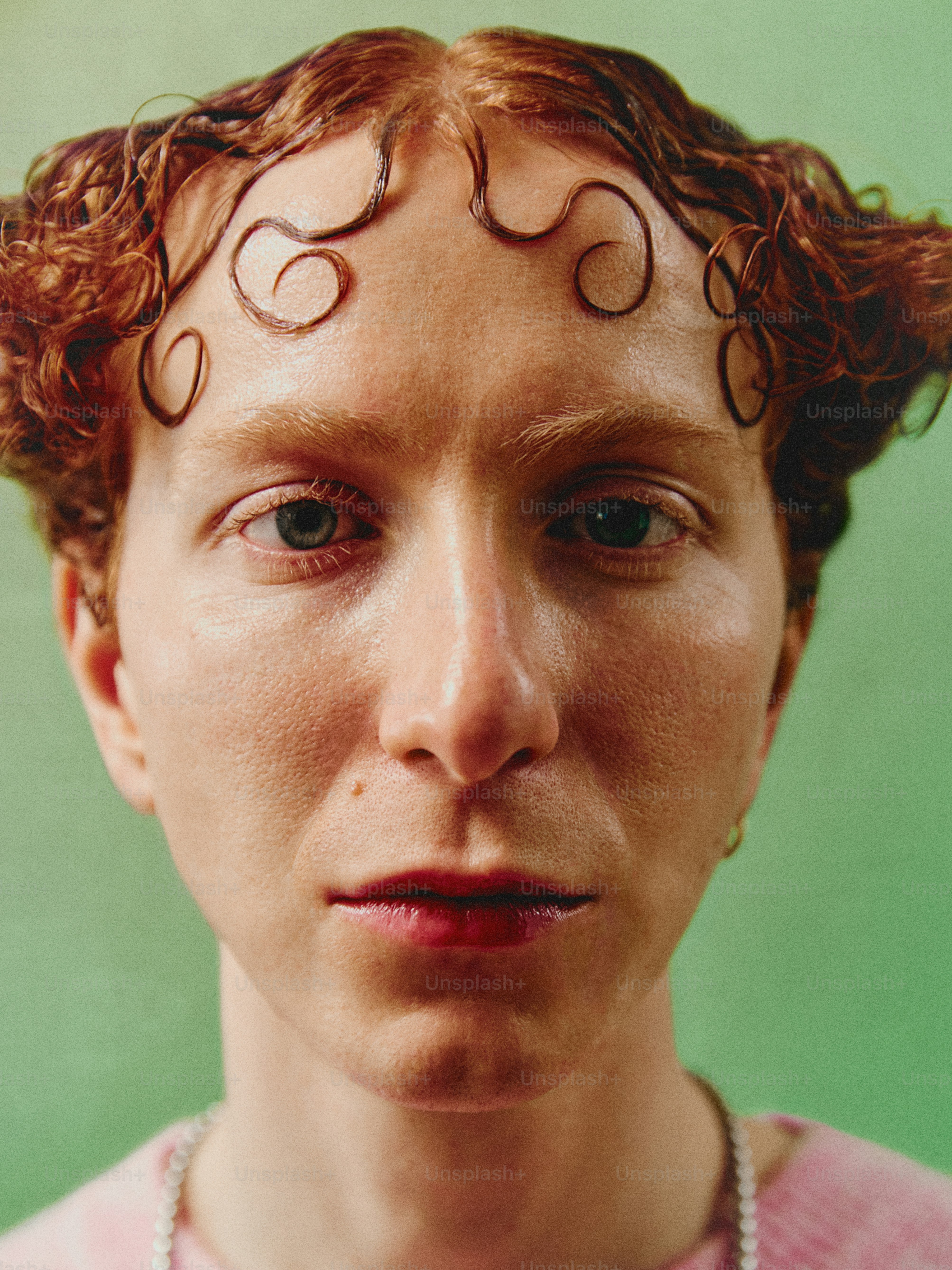 a close up of a person with curly hair