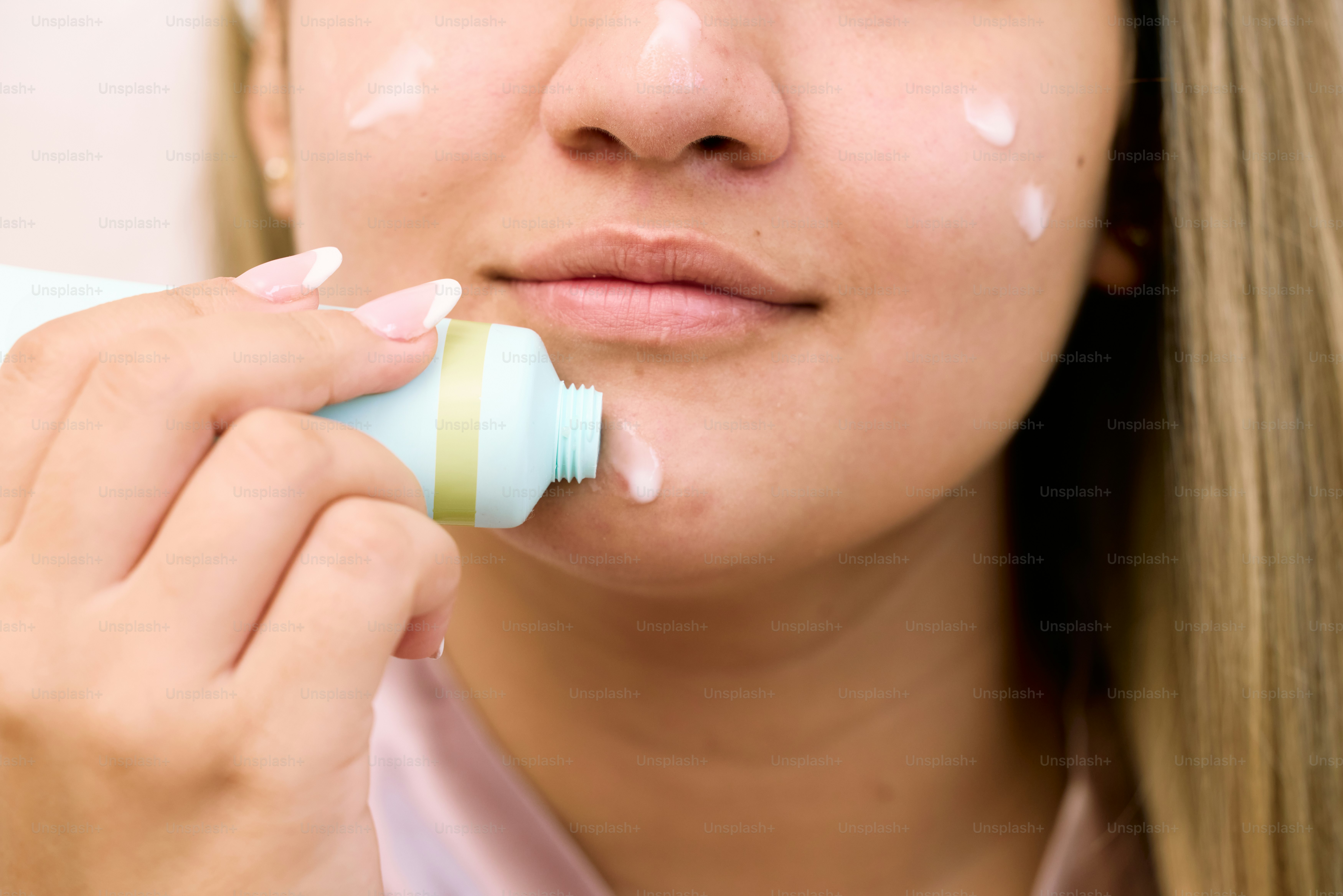 a woman using a toothbrush to brush her teeth