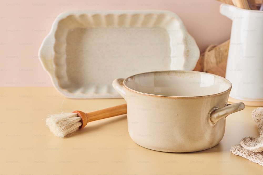 a cream colored mug with a wooden handle