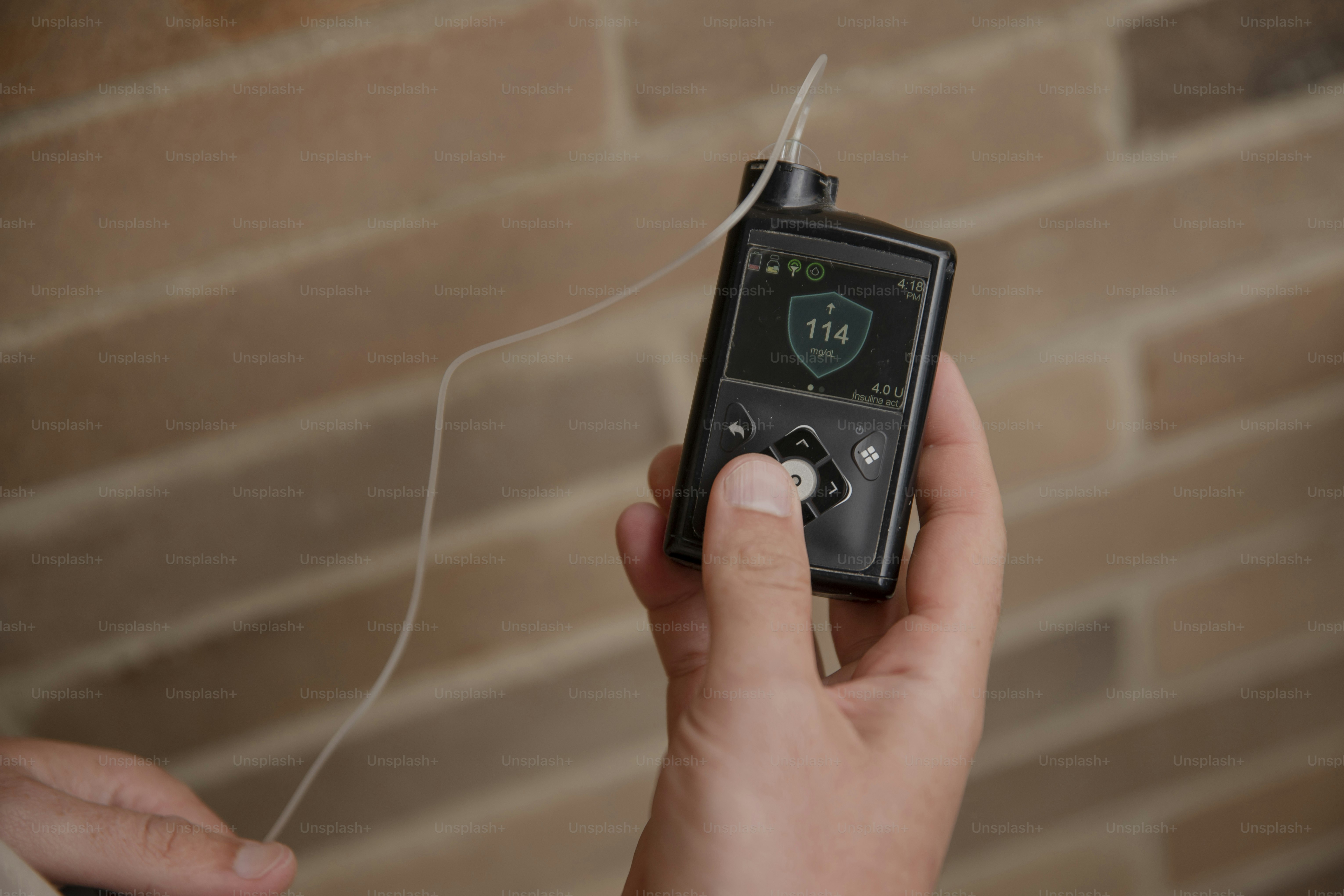 A person holding a remote control in their hand.
