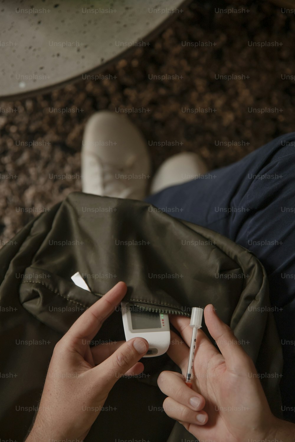 a person holding a cell phone in a bag