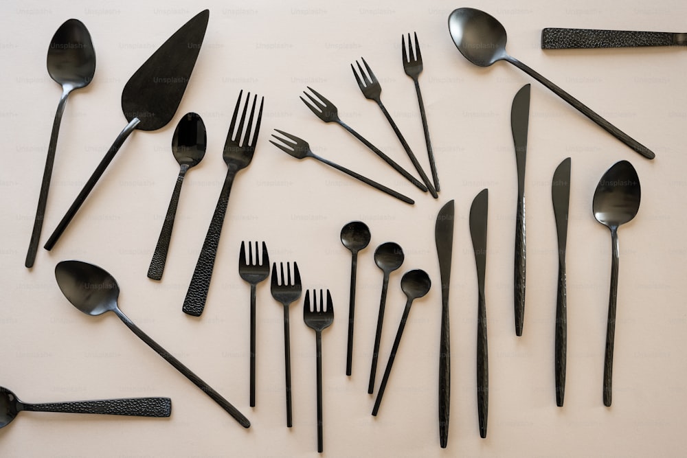 a collection of forks, spoons, and knives laid out in a circle