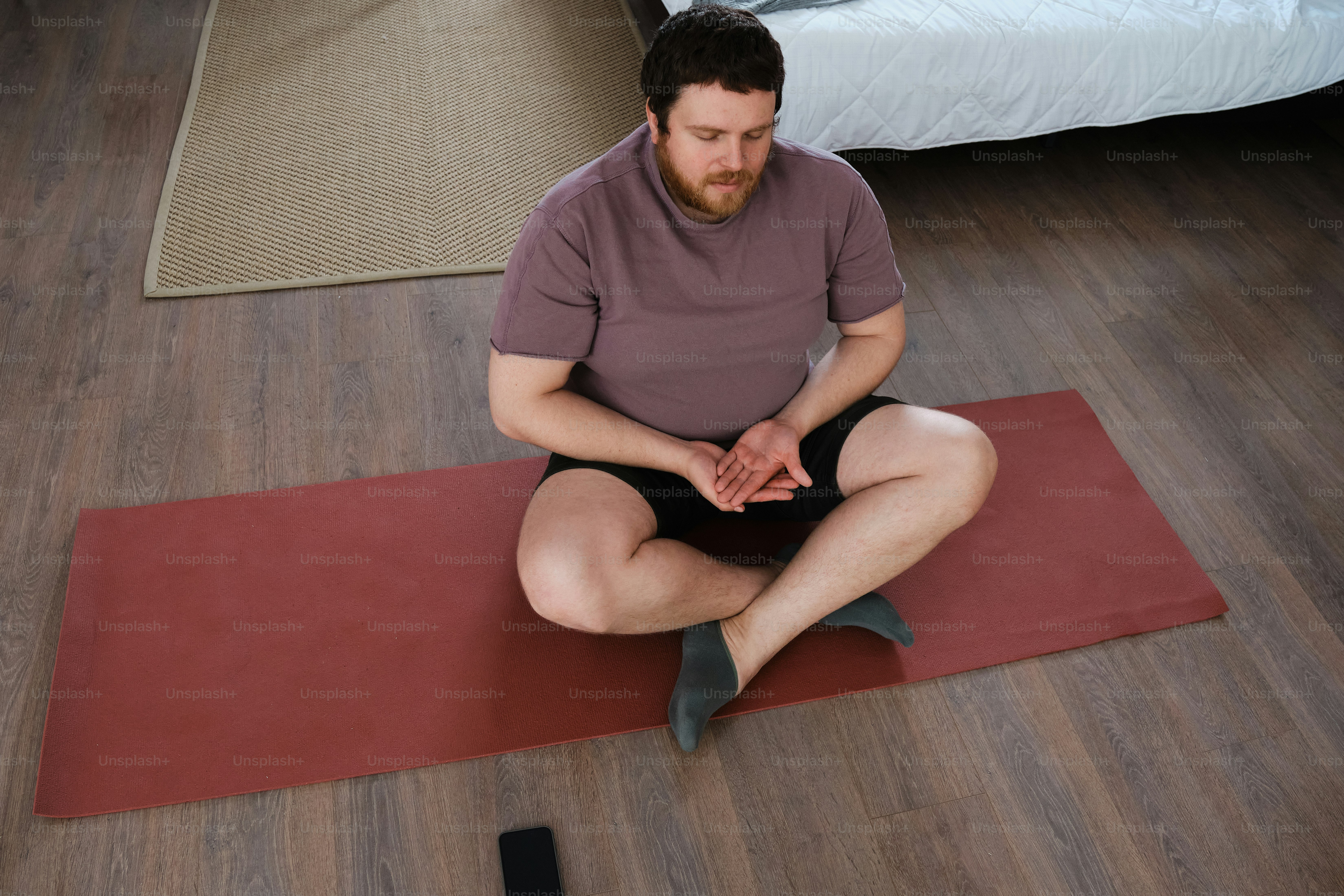 a plus size man doing yoga asana at home