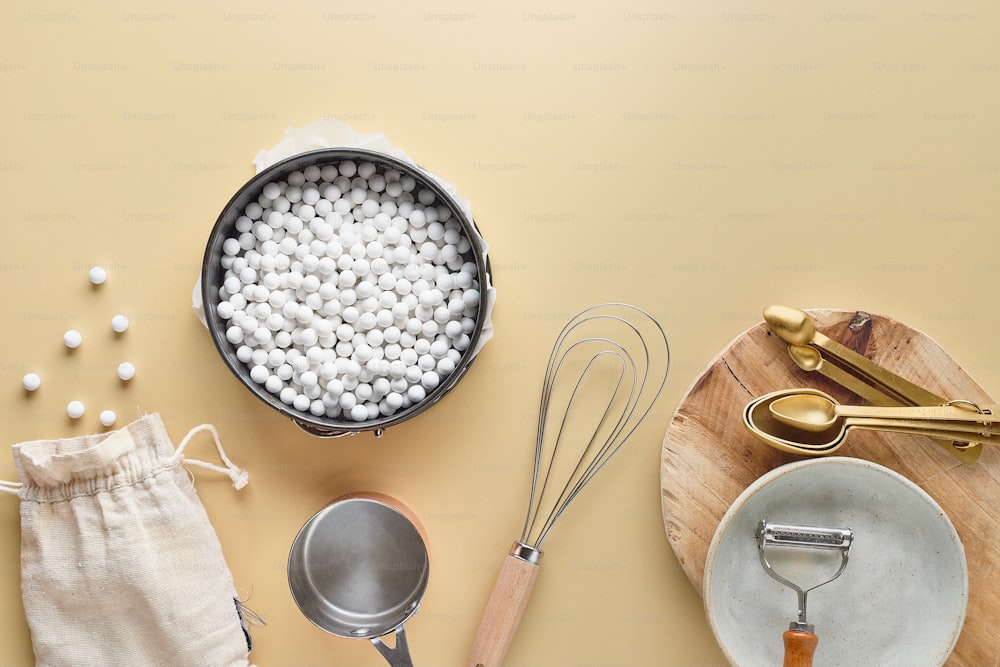 a table topped with a pan filled with white balls