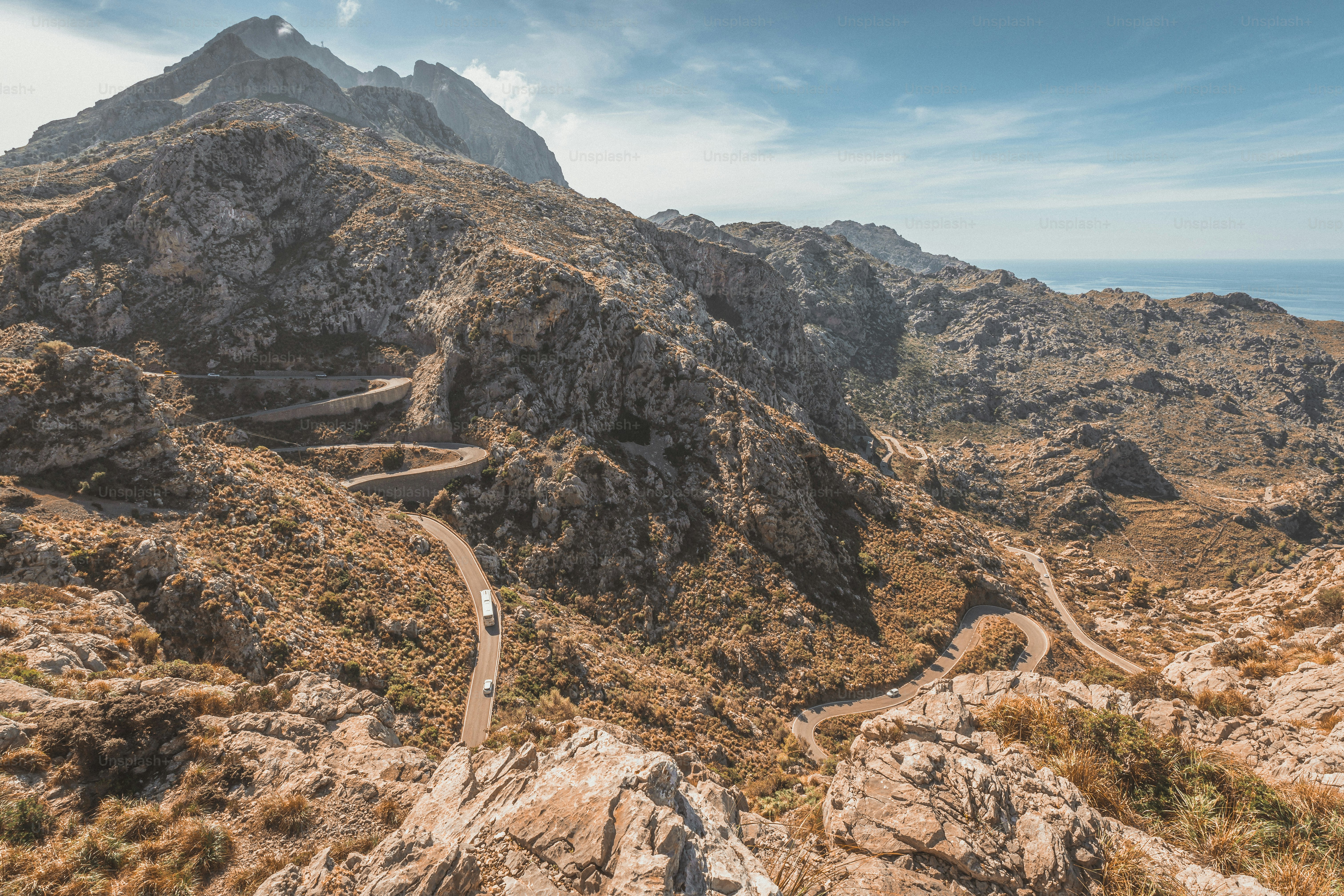 a mountain with a winding road in the middle of it