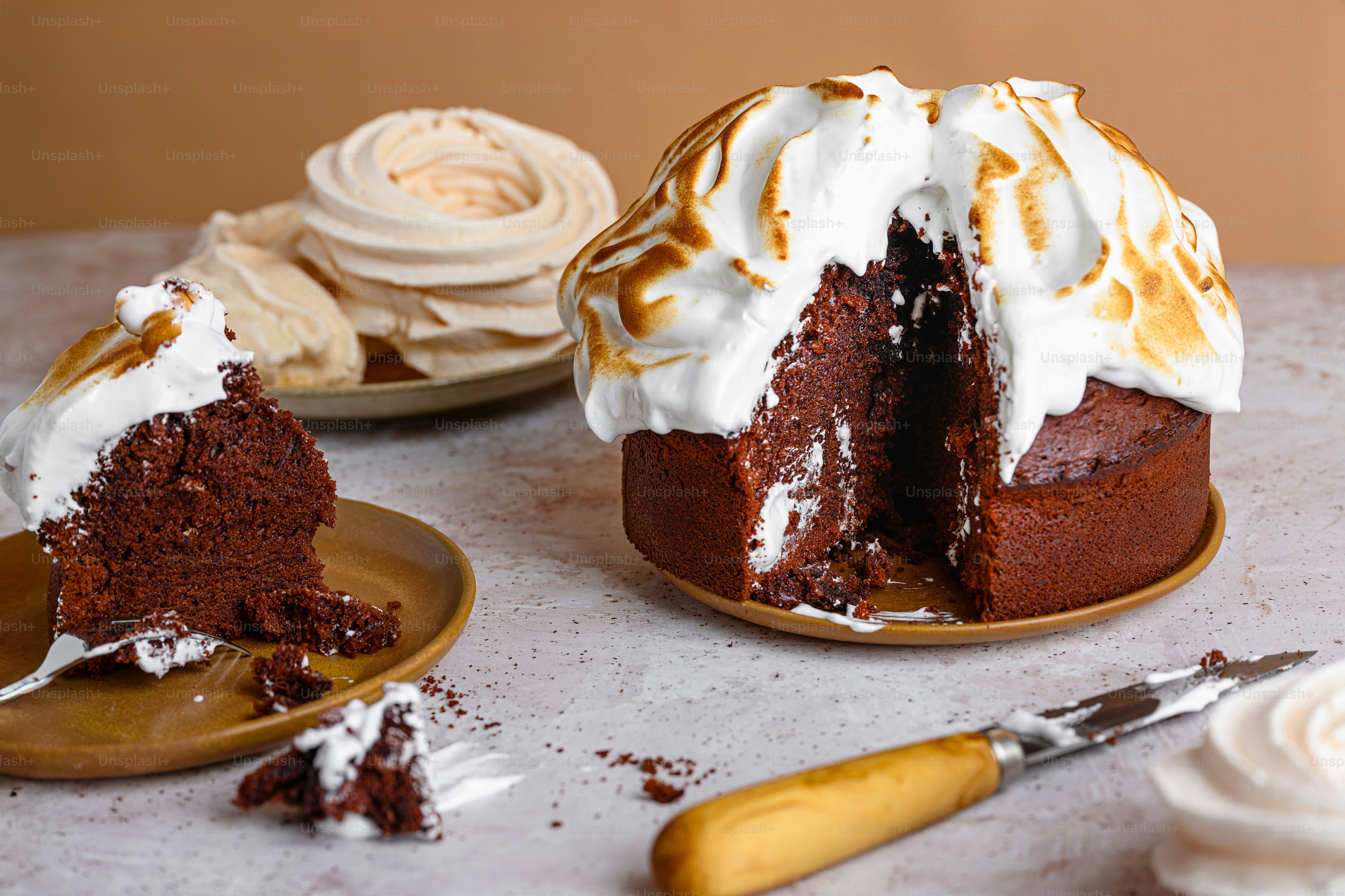 a chocolate cake with white frosting on a table