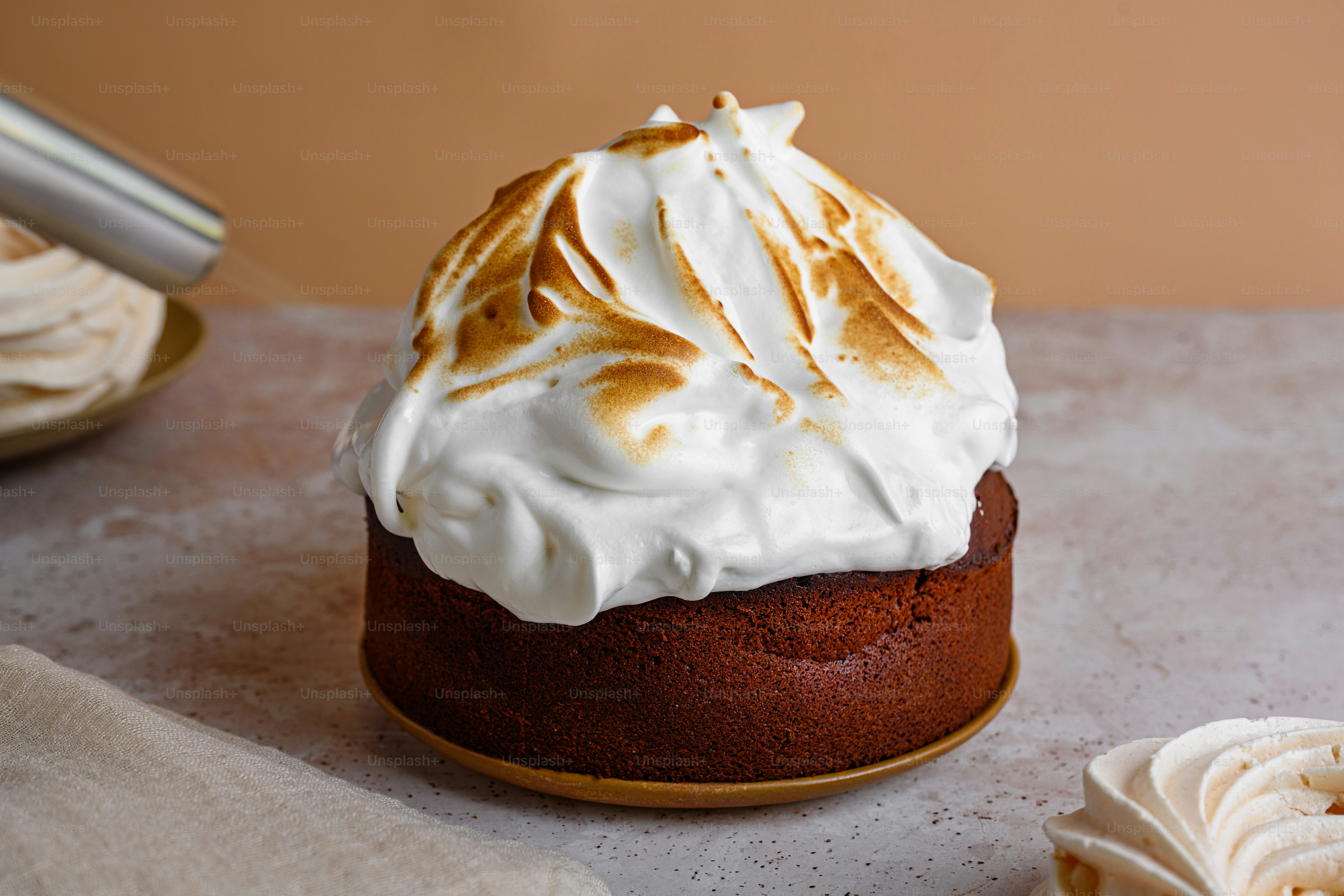 a cake topped with whipped cream on top of a table
