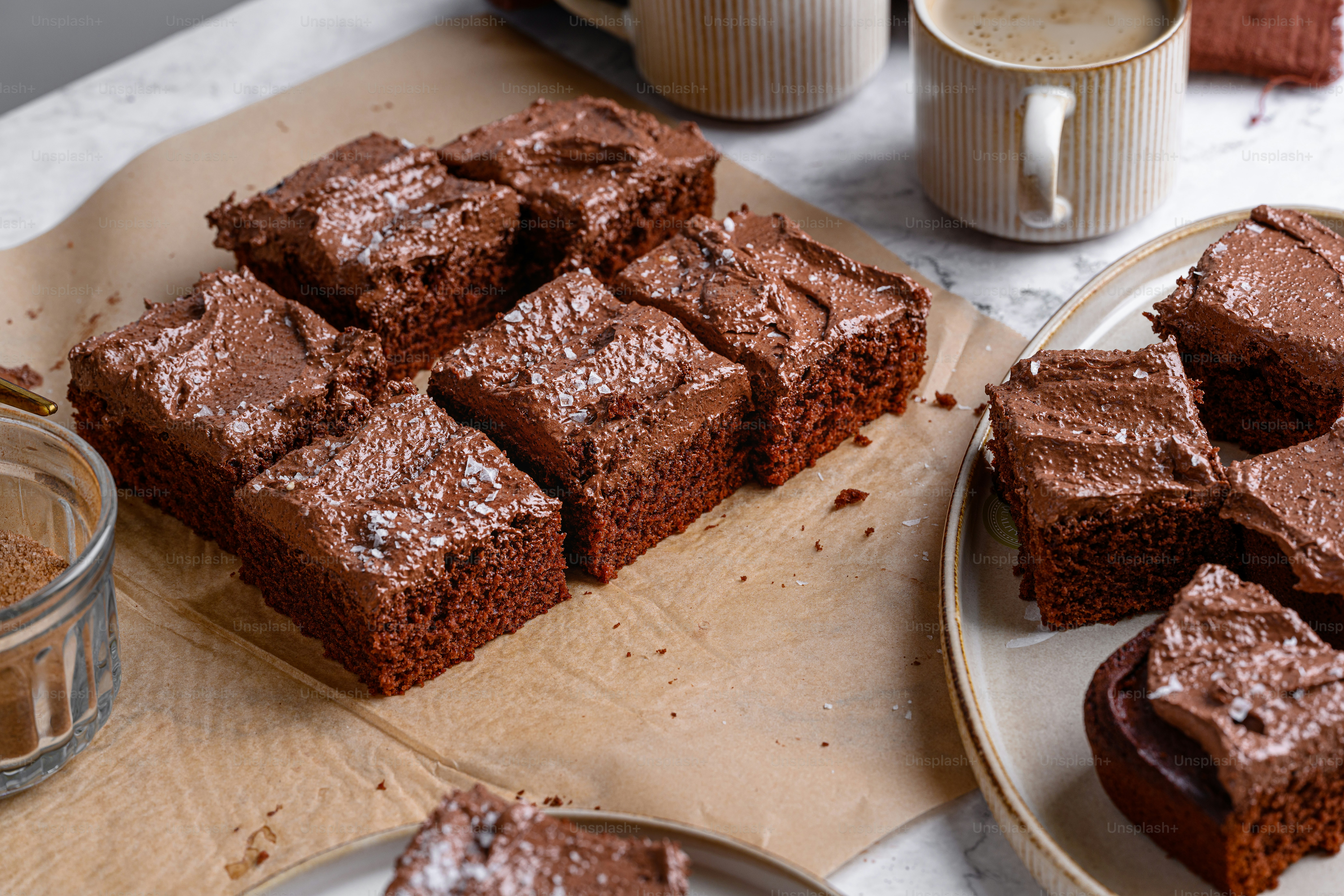 a table topped with slices of brownies next to a cup of coffee
