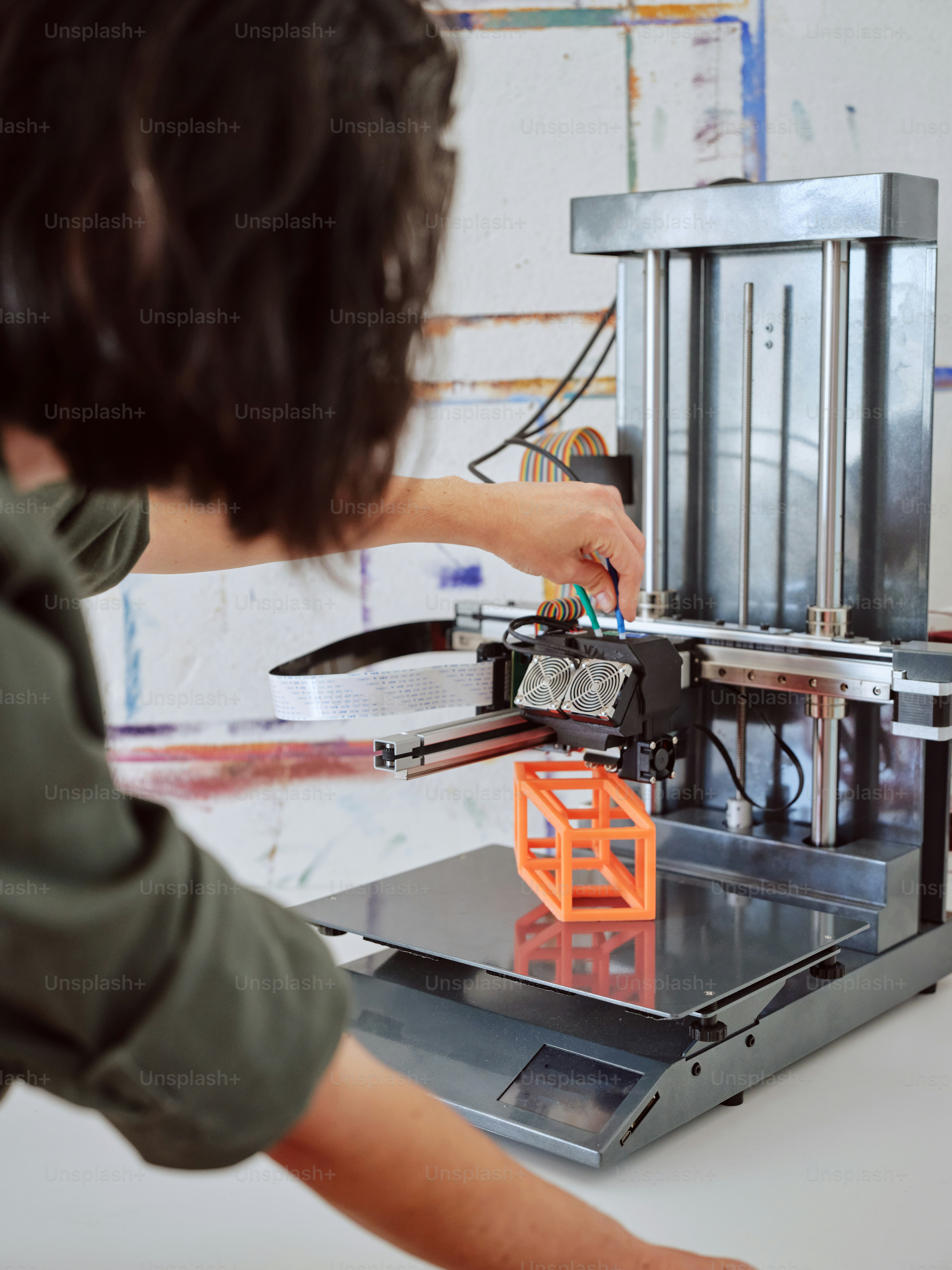 a man is working on a 3d printer