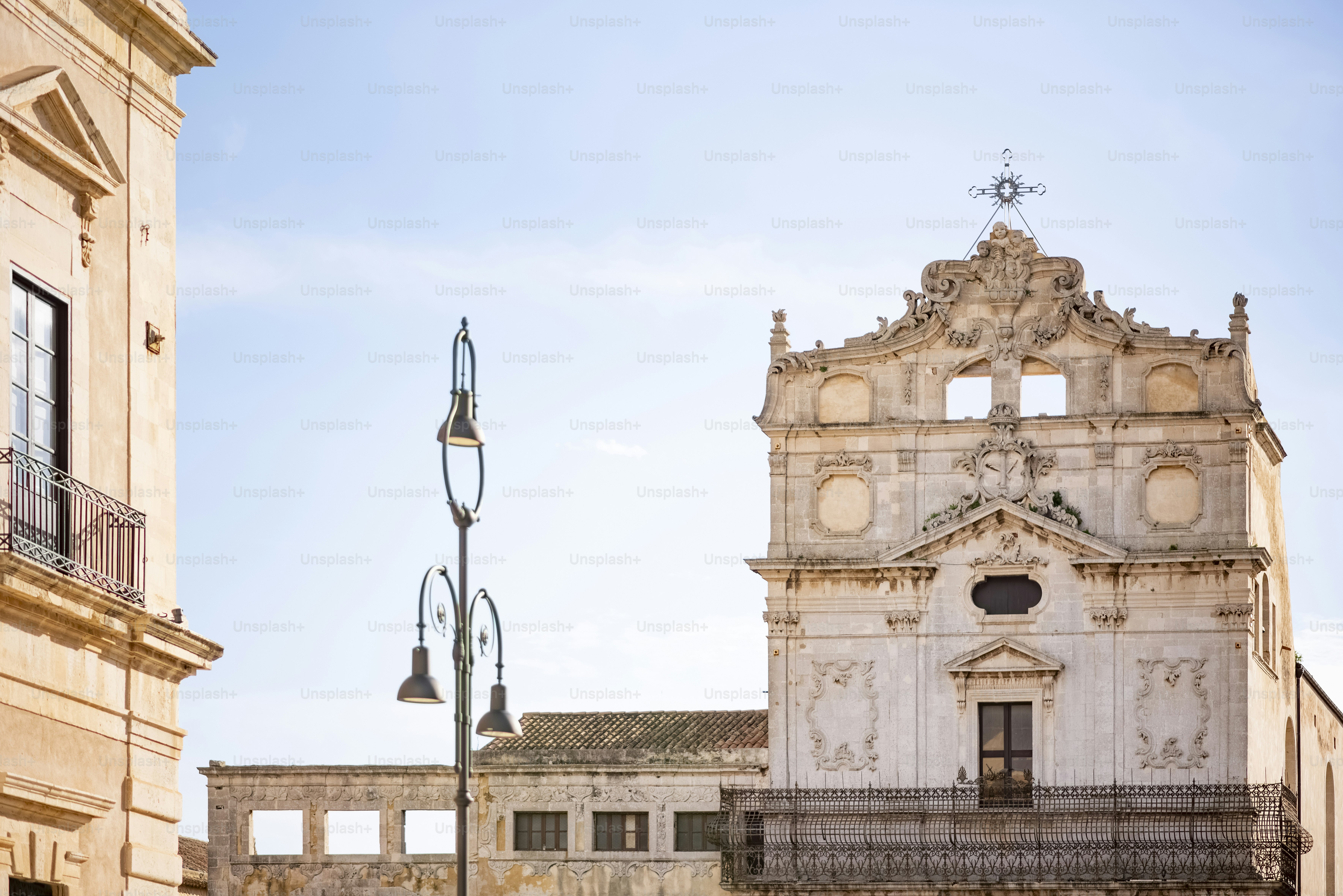 a tall white building with a clock on it's side