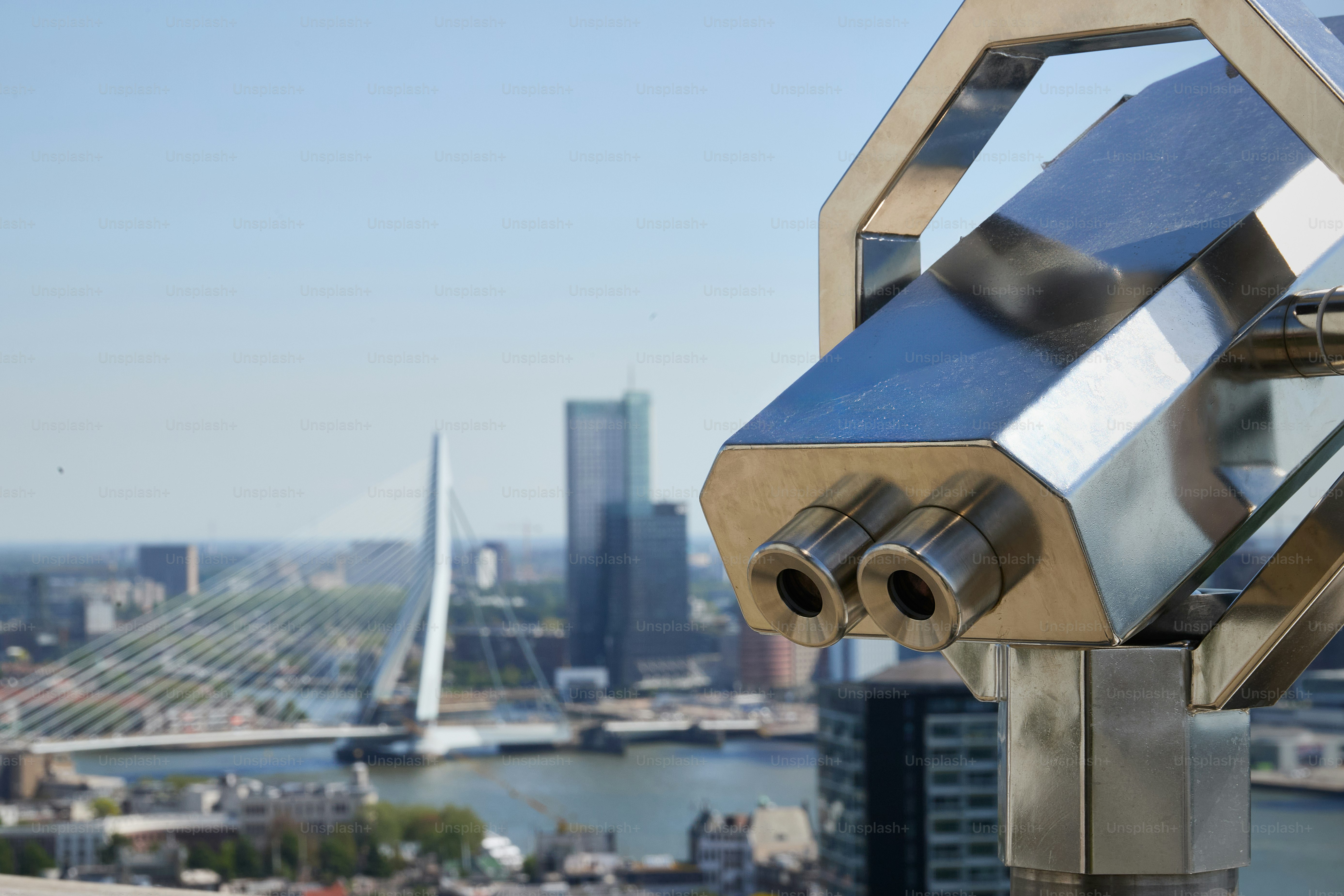 a telescope on top of a building with a city in the background