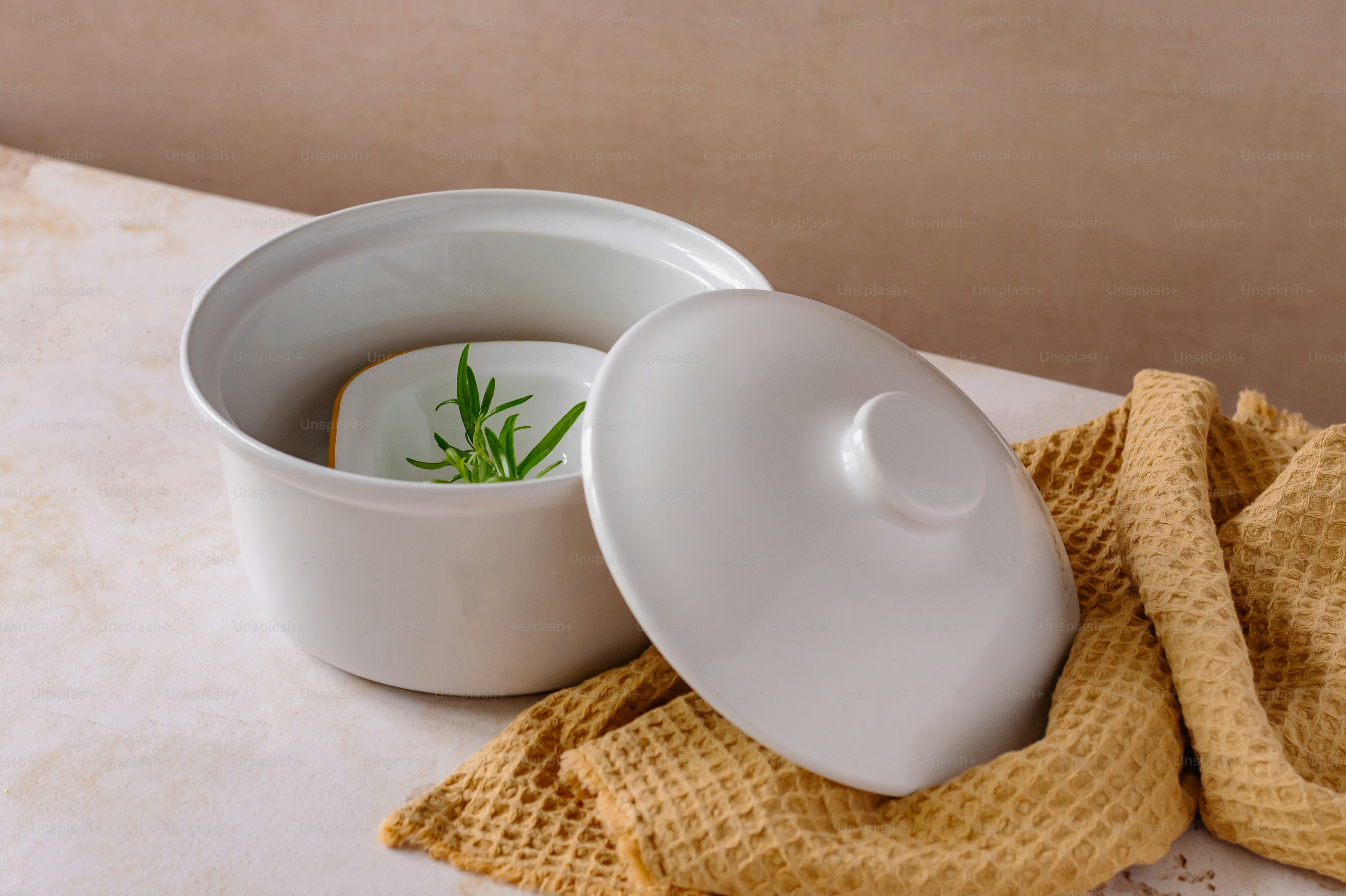 a bowl of soup with a sprig of rosemary in it