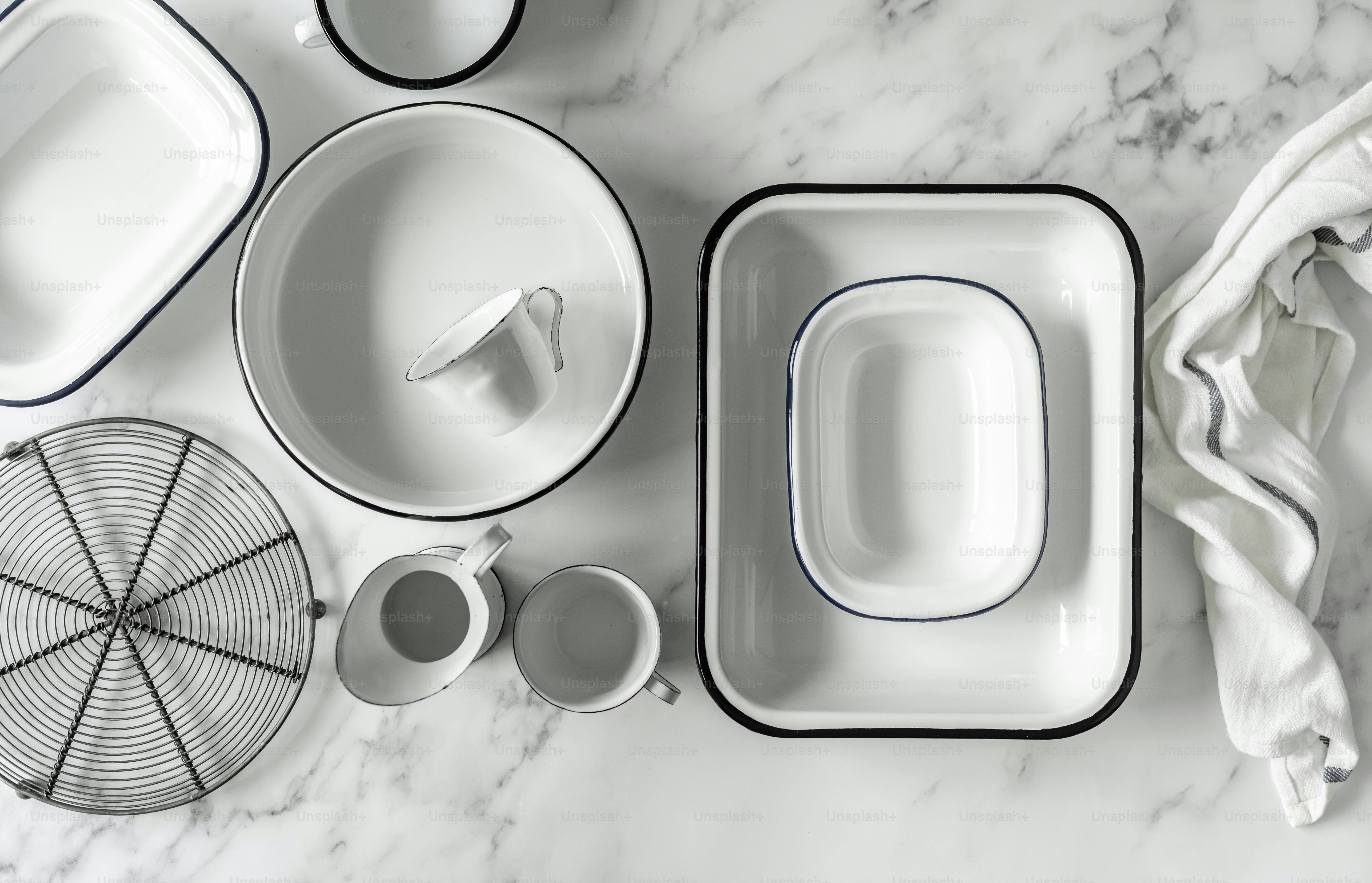 a marble table topped with dishes and cups