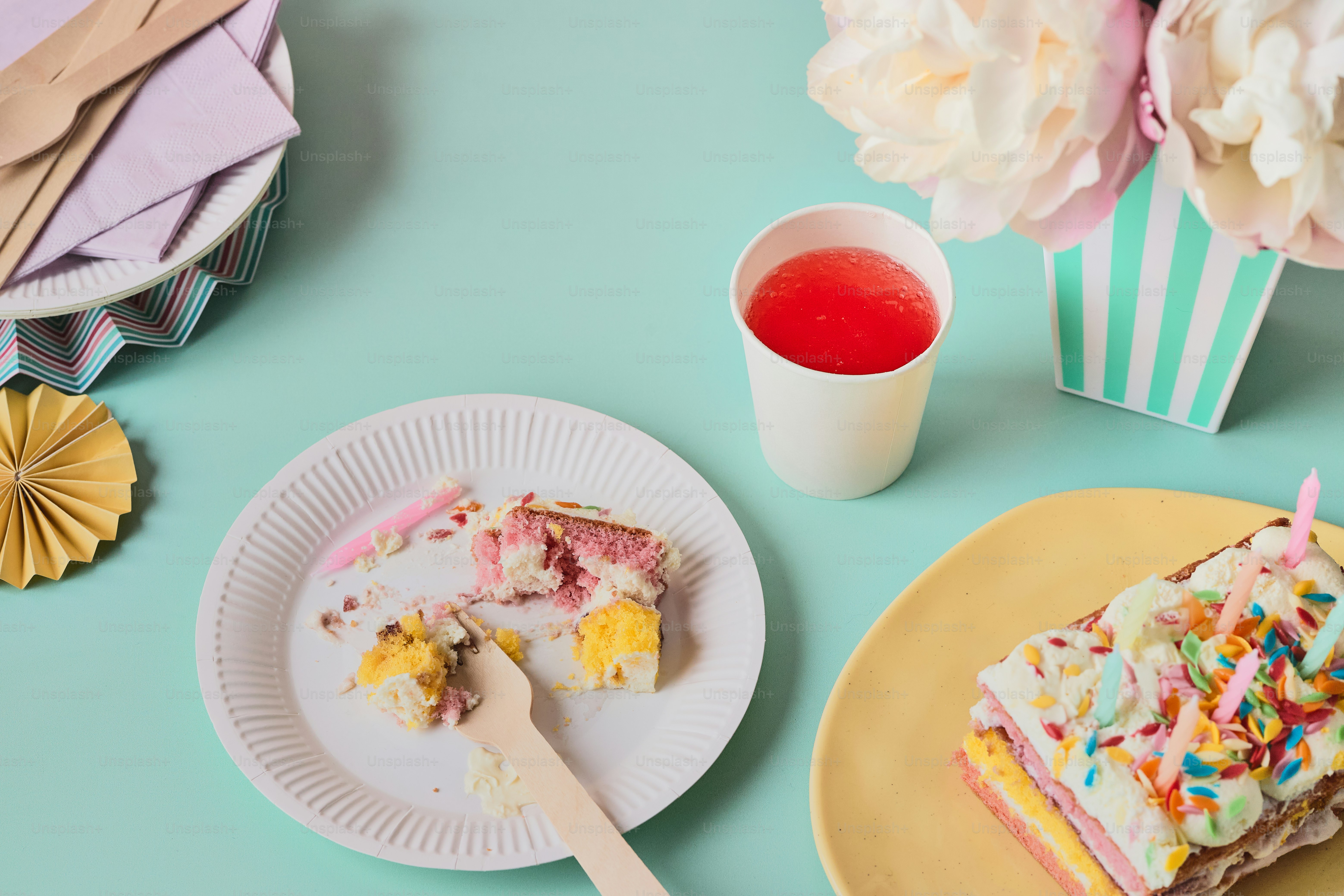 a piece of cake on a plate next to a cup of tea
