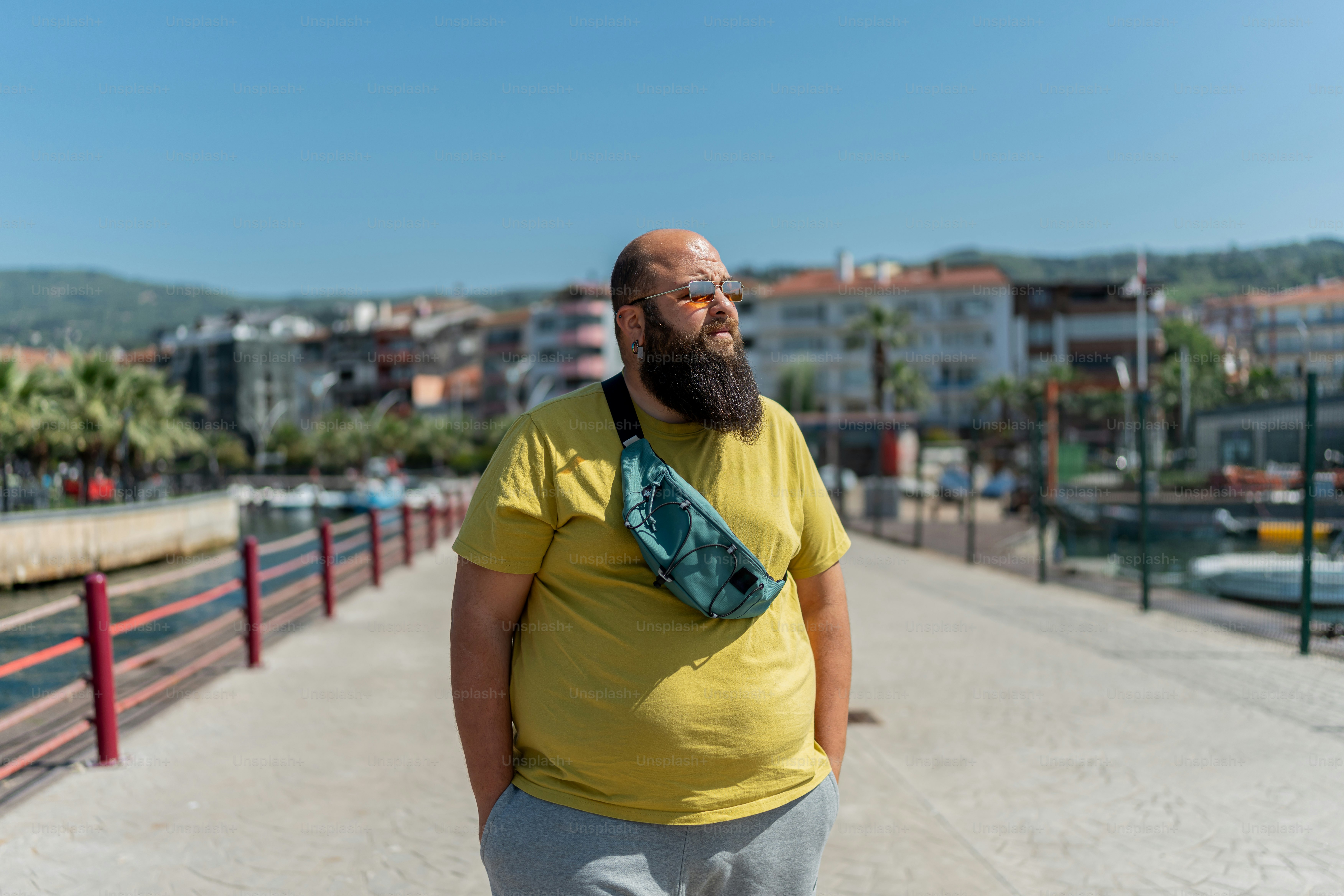 a man with a beard wearing a yellow shirt