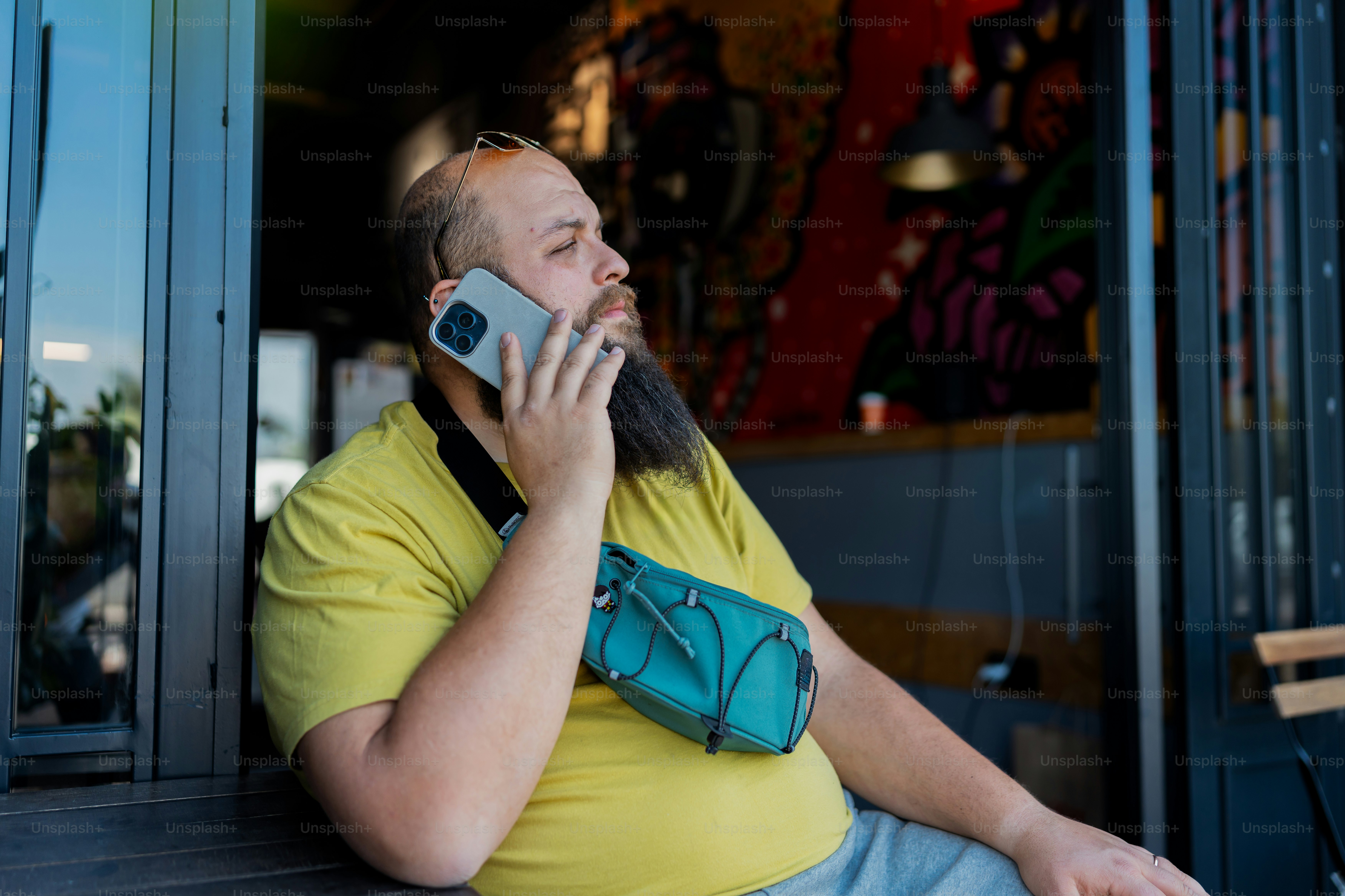 a man sitting on a bench talking on a cell phone