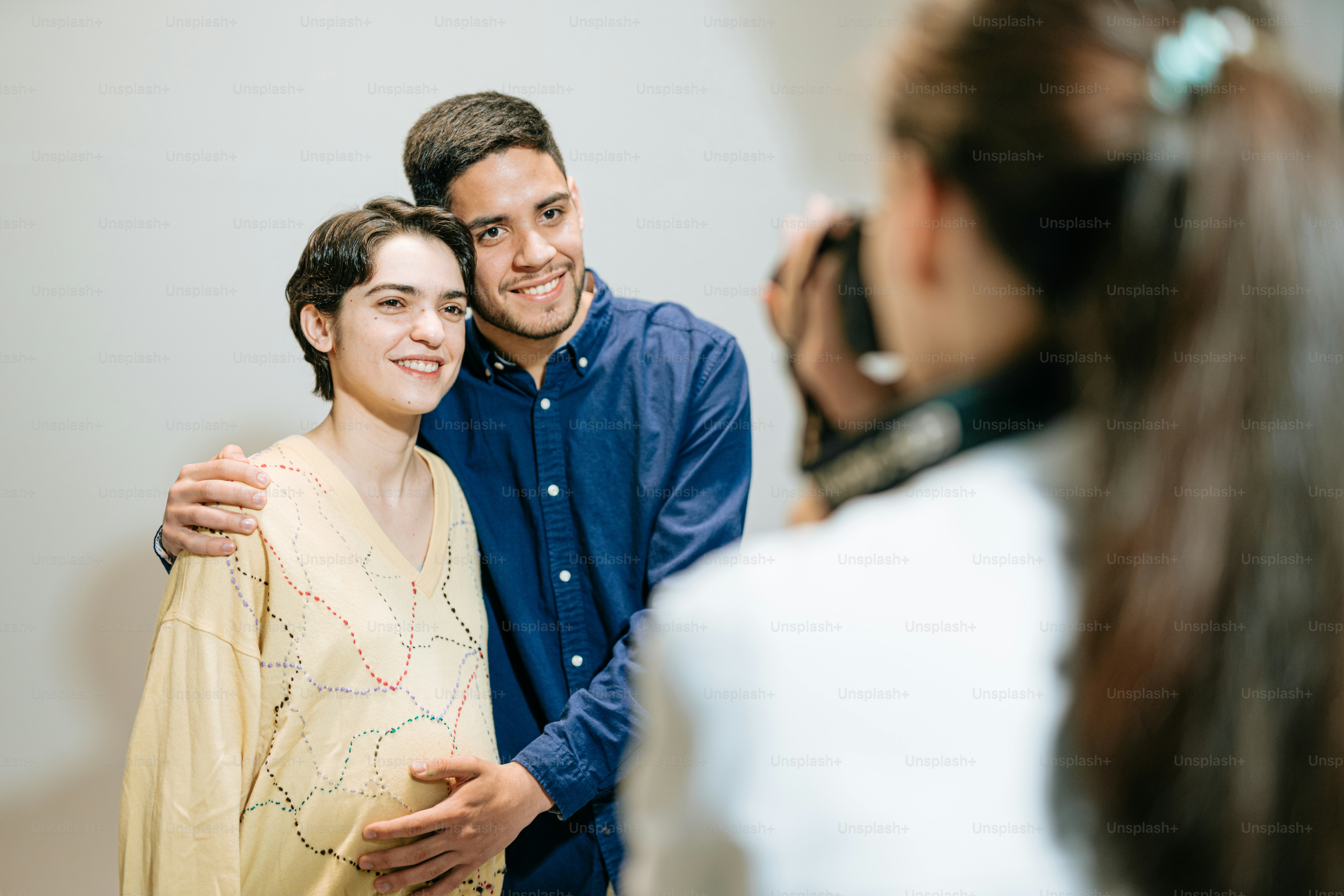 a man taking a picture of a woman with a cell phone