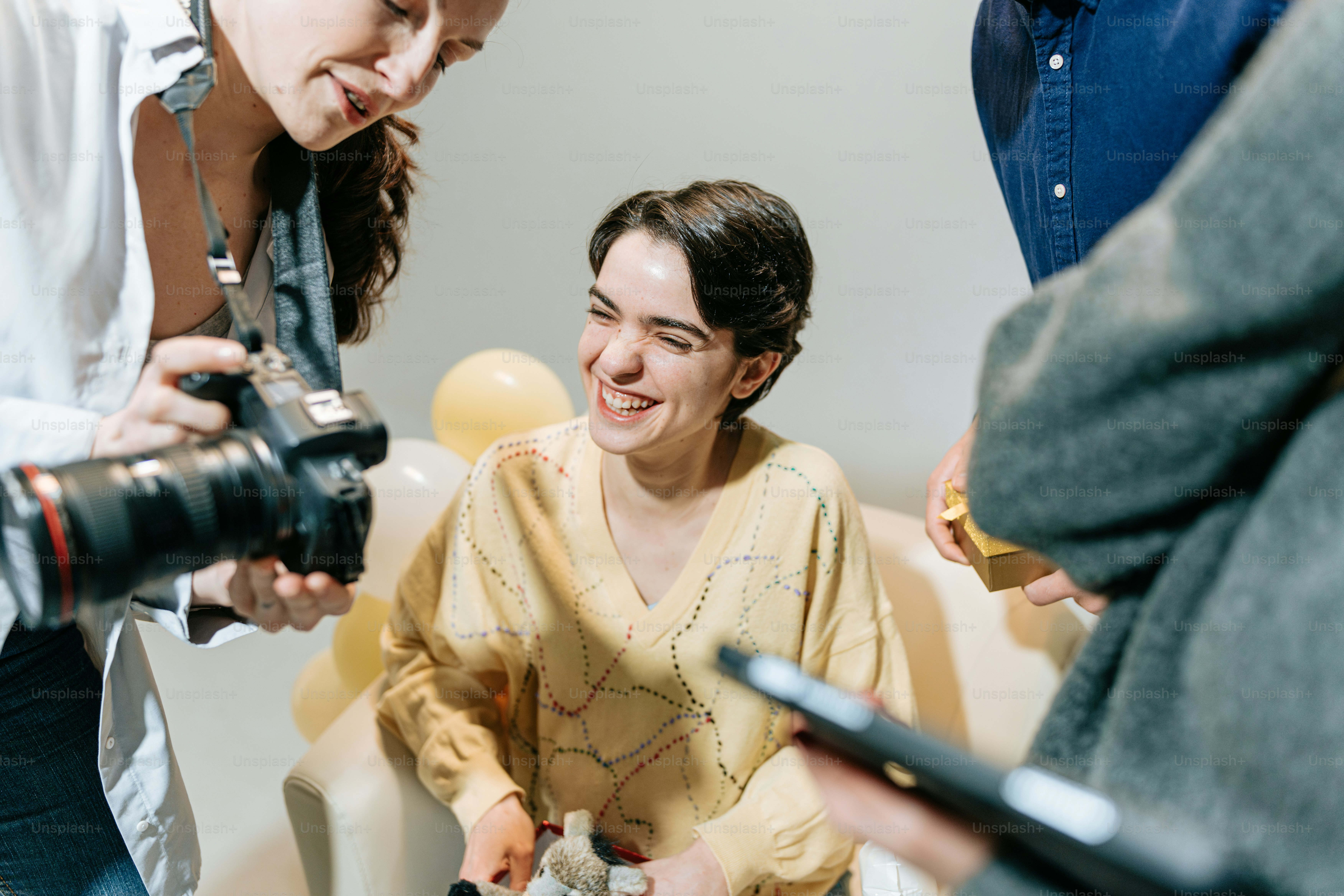 a woman sitting in a chair holding a camera