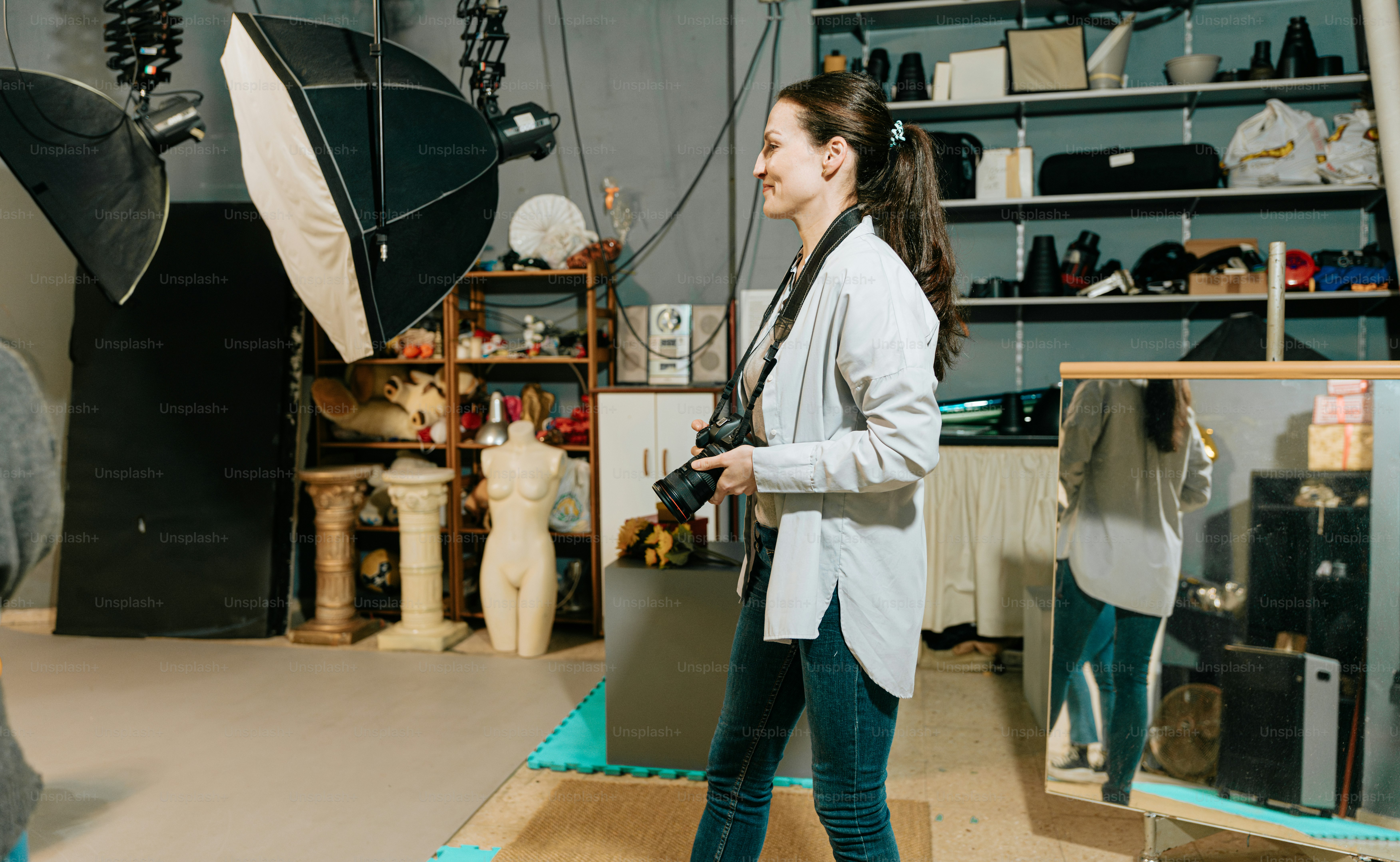 a woman standing in front of a camera in a studio