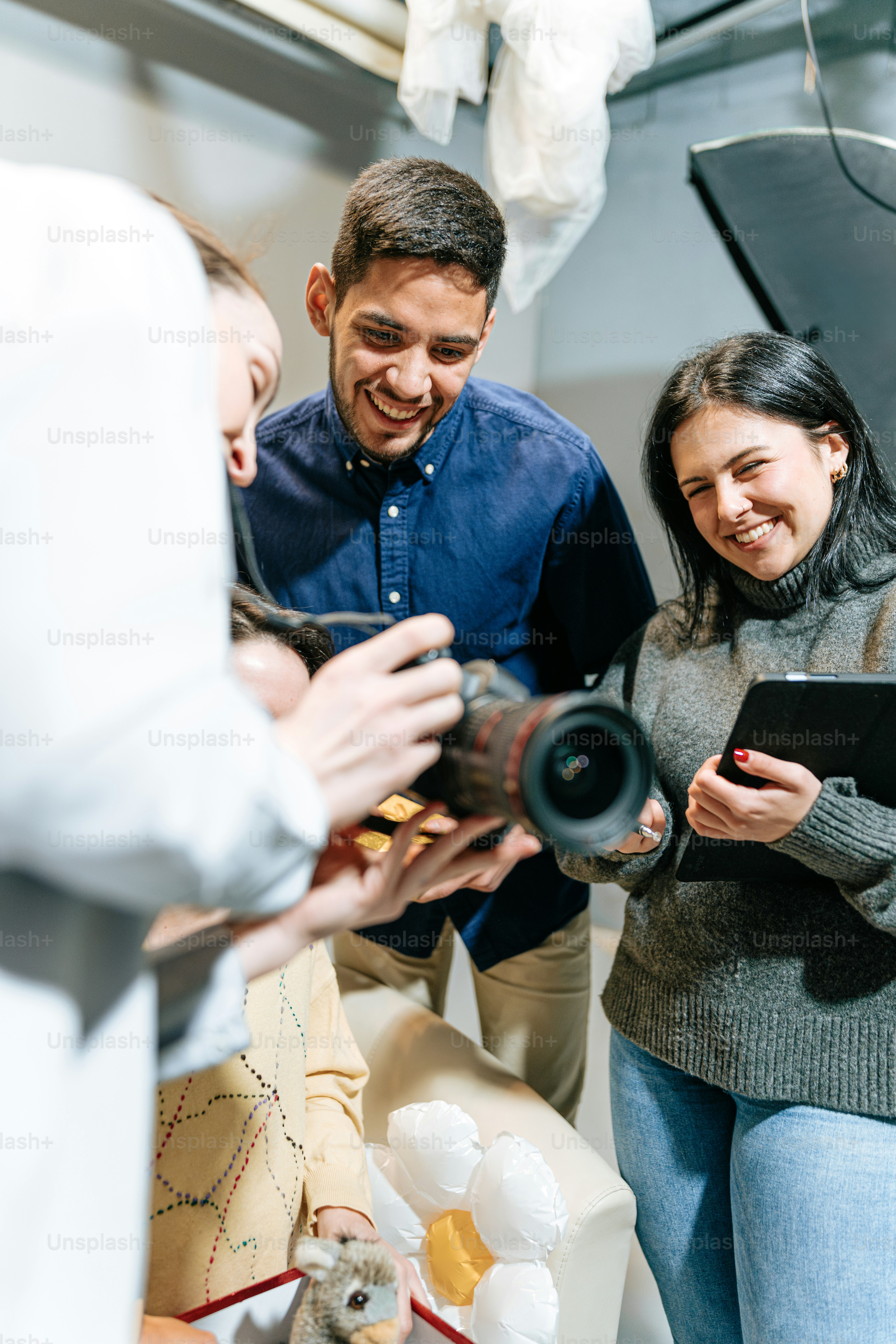 a group of people standing around a camera