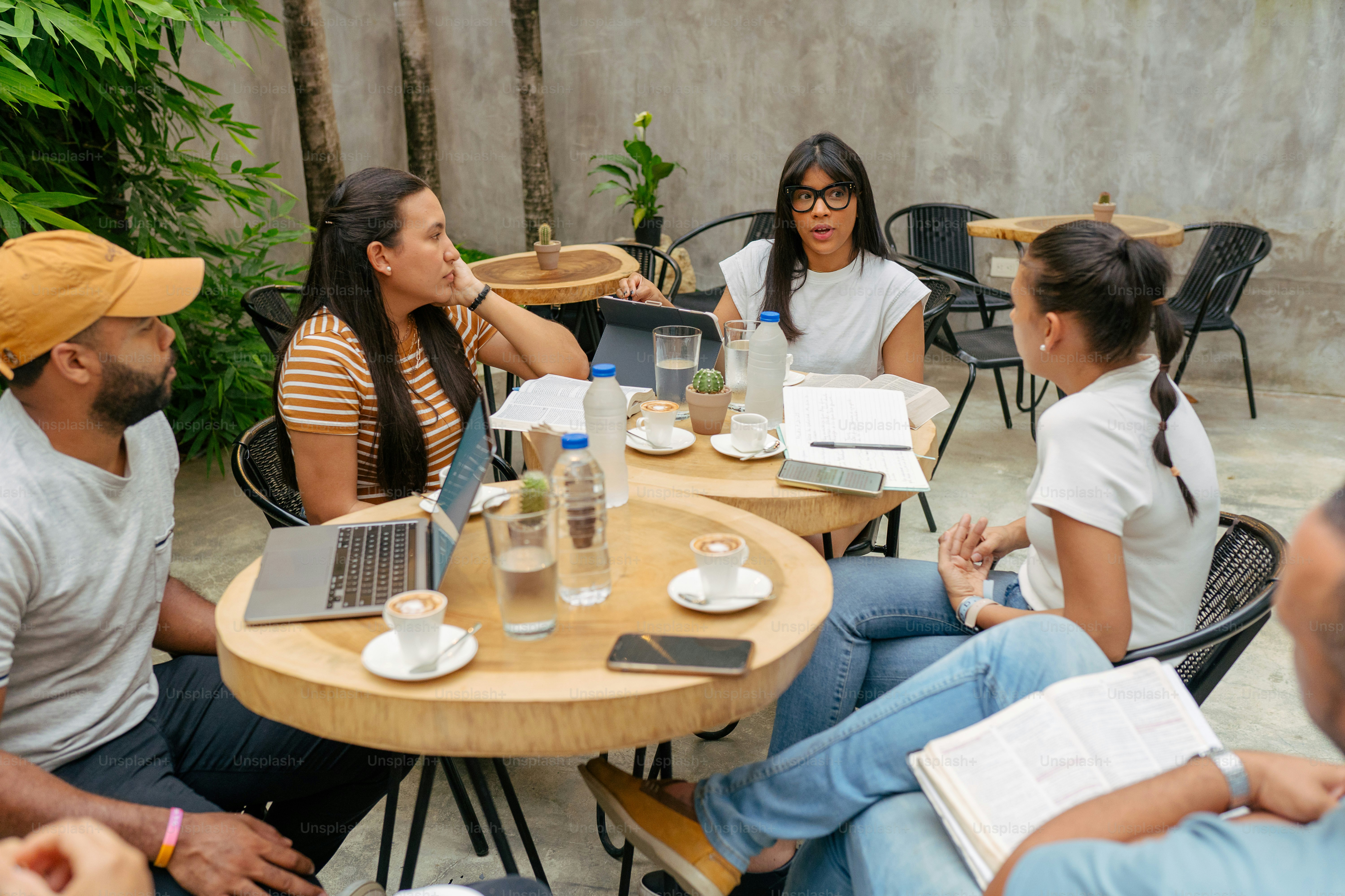 a group of people sitting around a wooden table