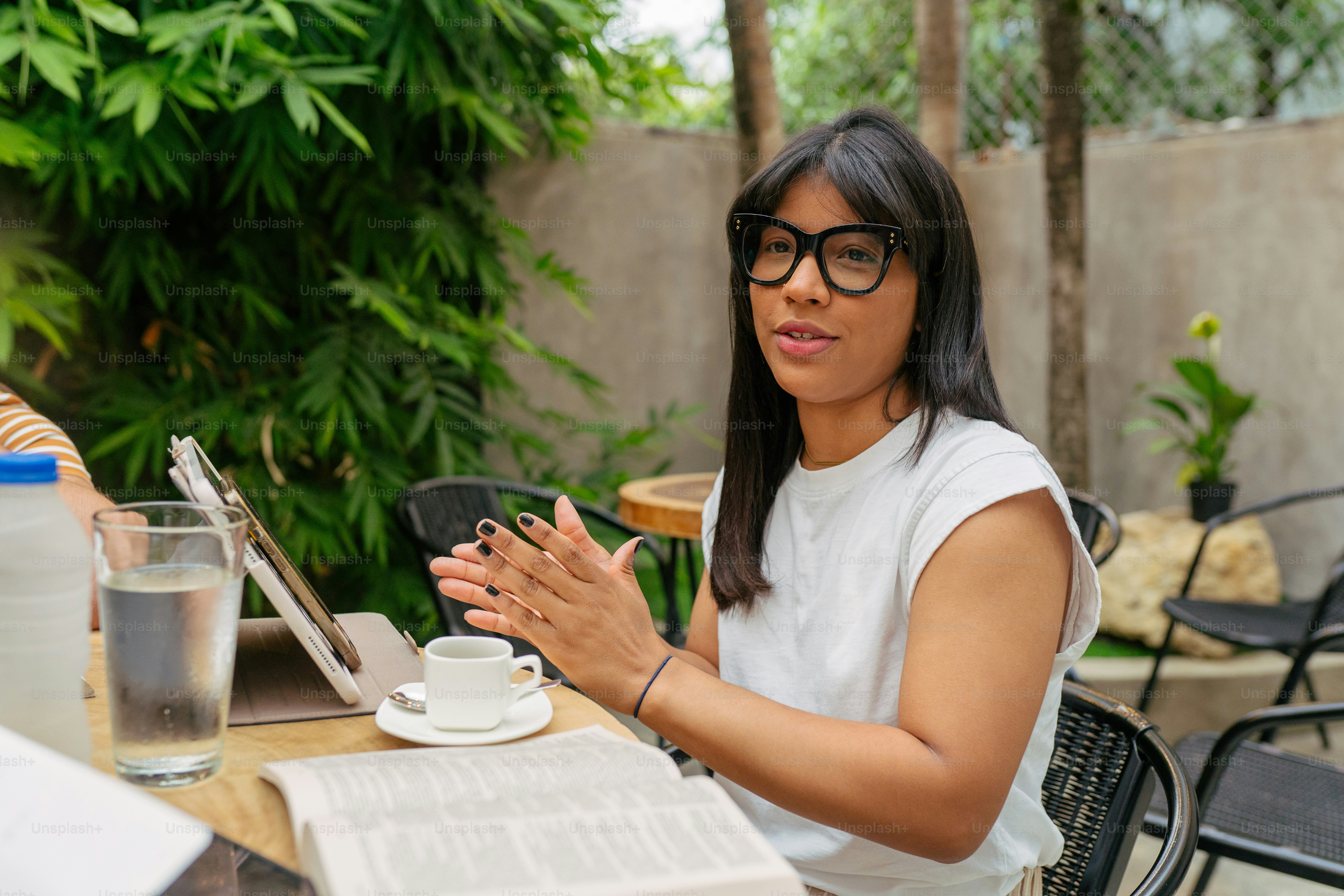 a woman sitting at a table with a laptop