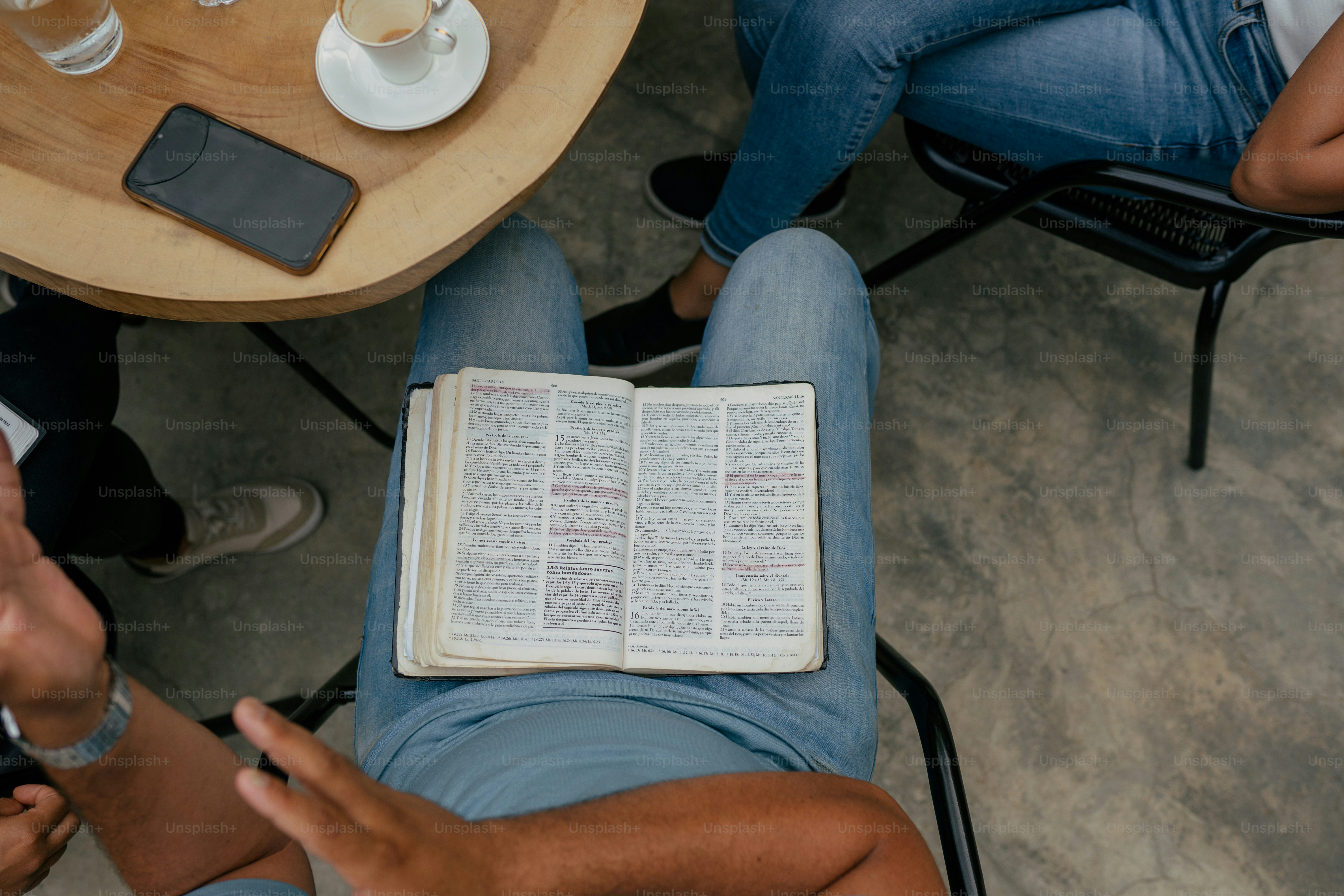 a man sitting in a chair reading a book