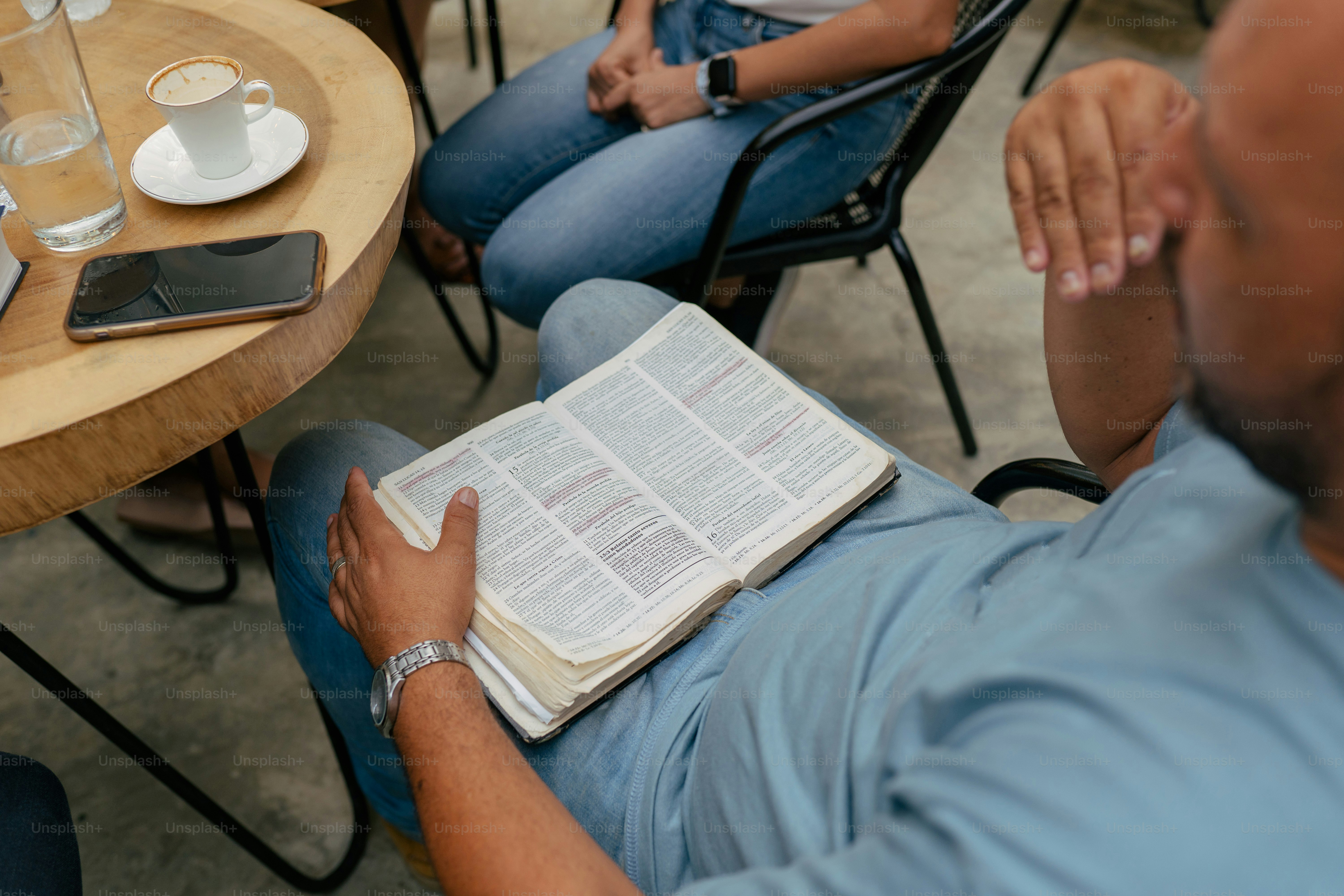 a man sitting in a chair reading a book
