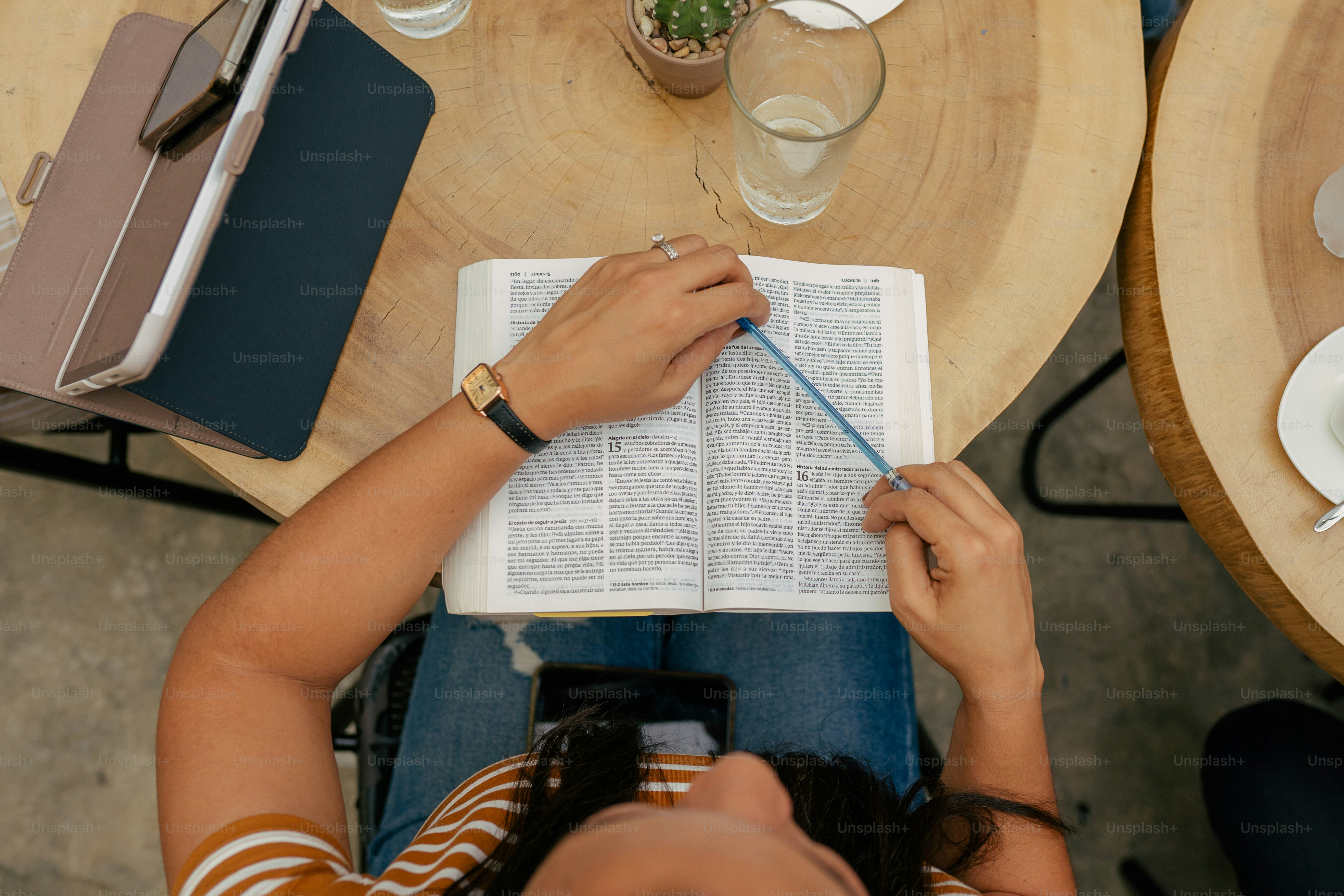 a person sitting at a table with an open book