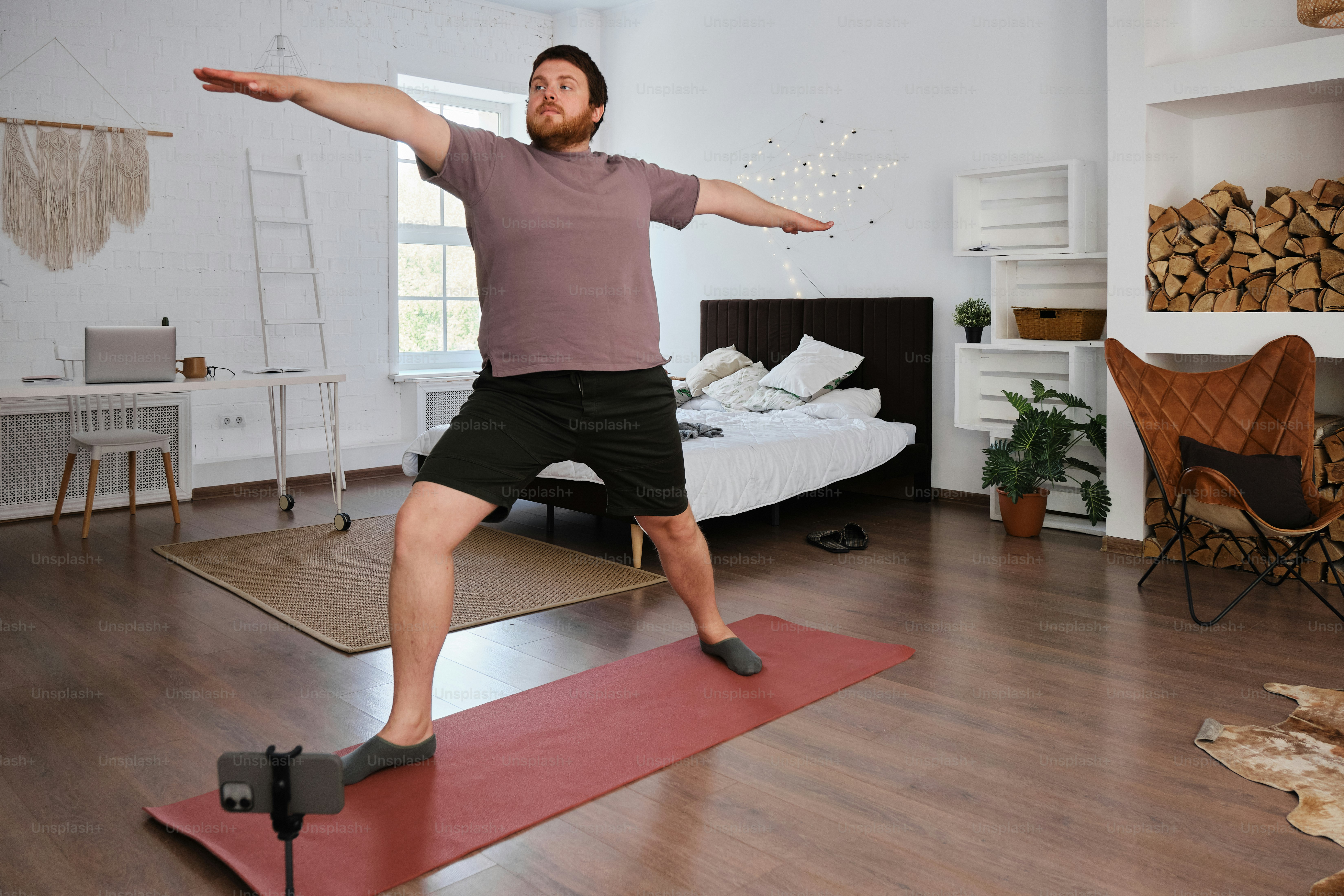 a man standing on a yoga mat in a room