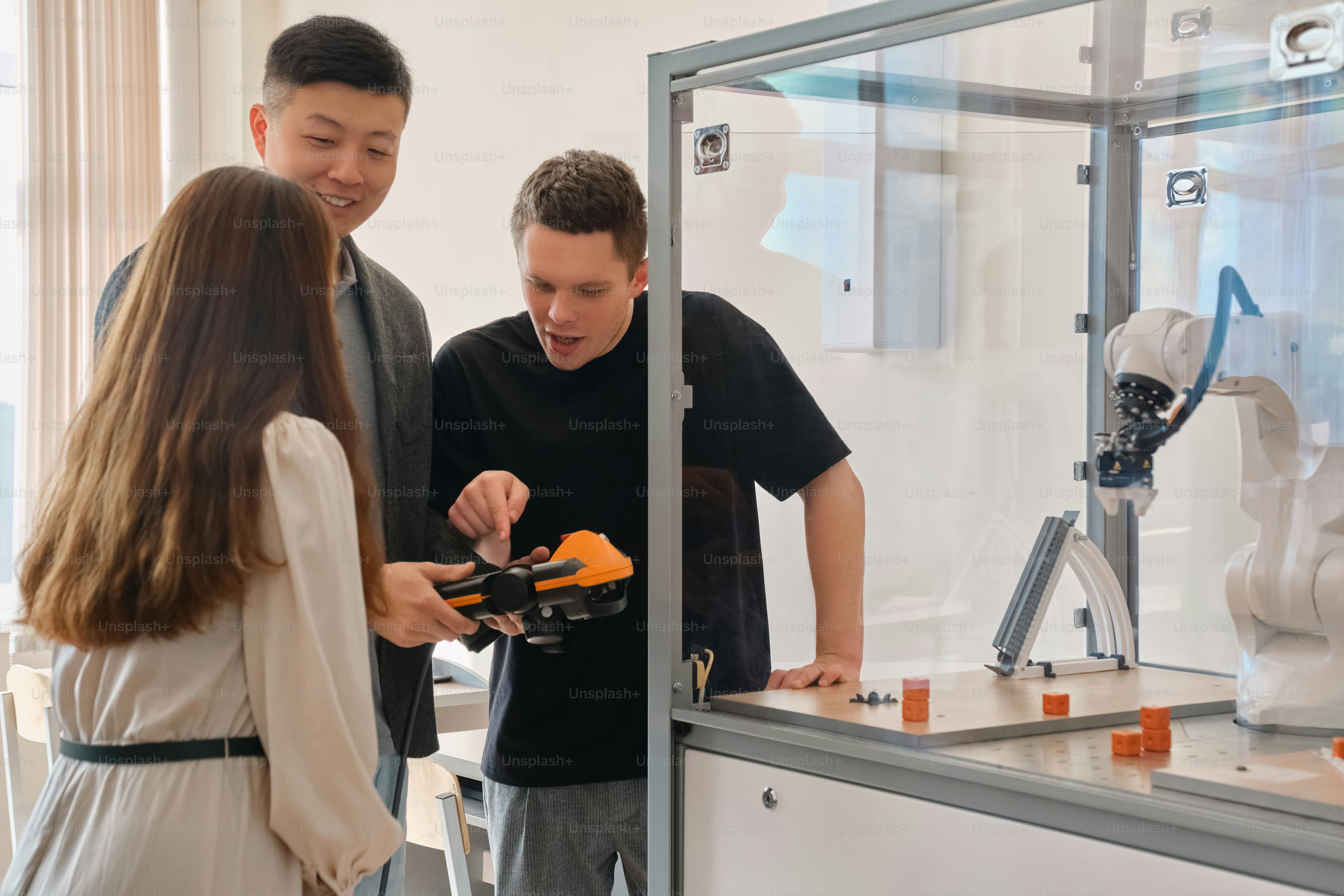 a group of people standing around a machine