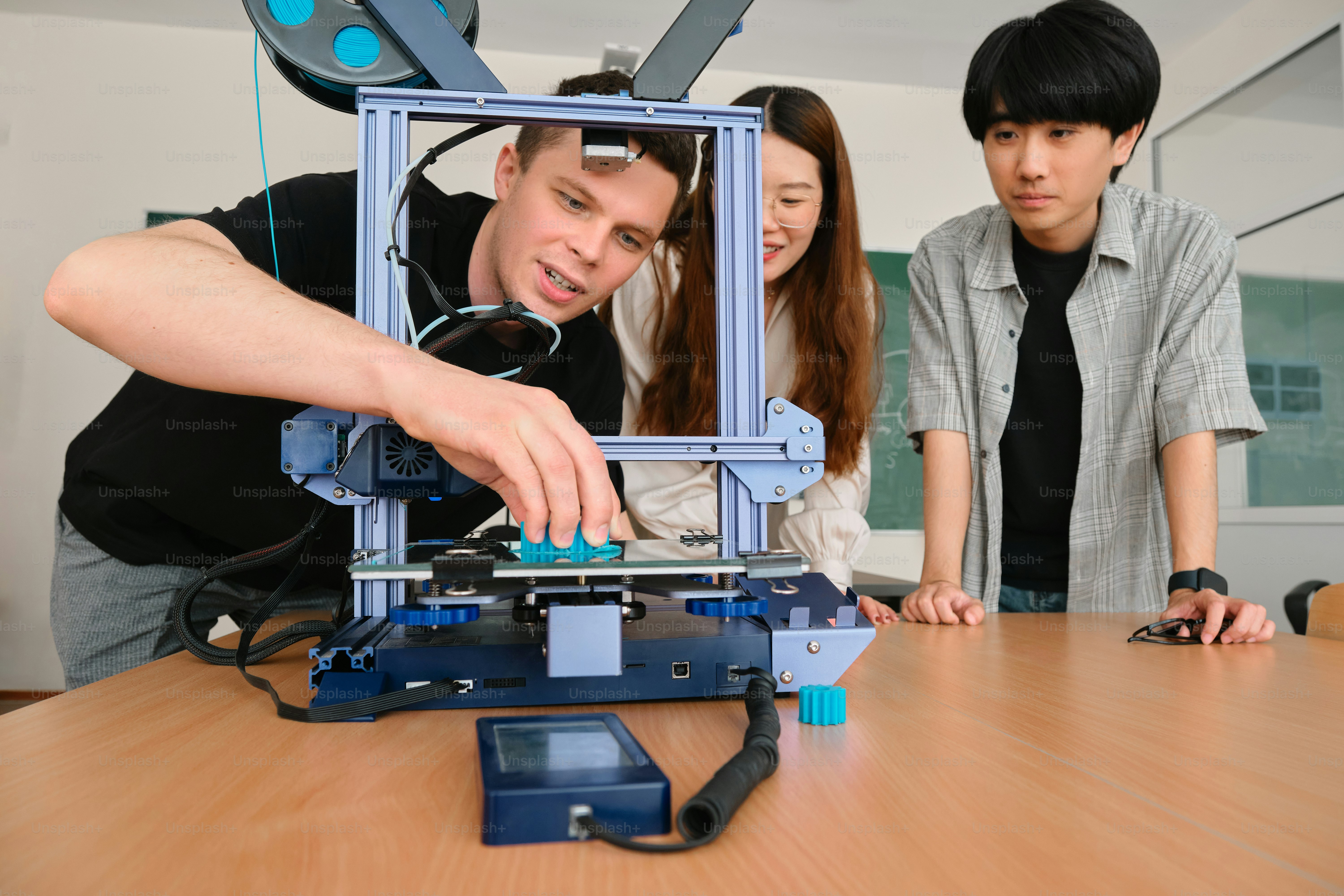 a group of people standing around a wooden table