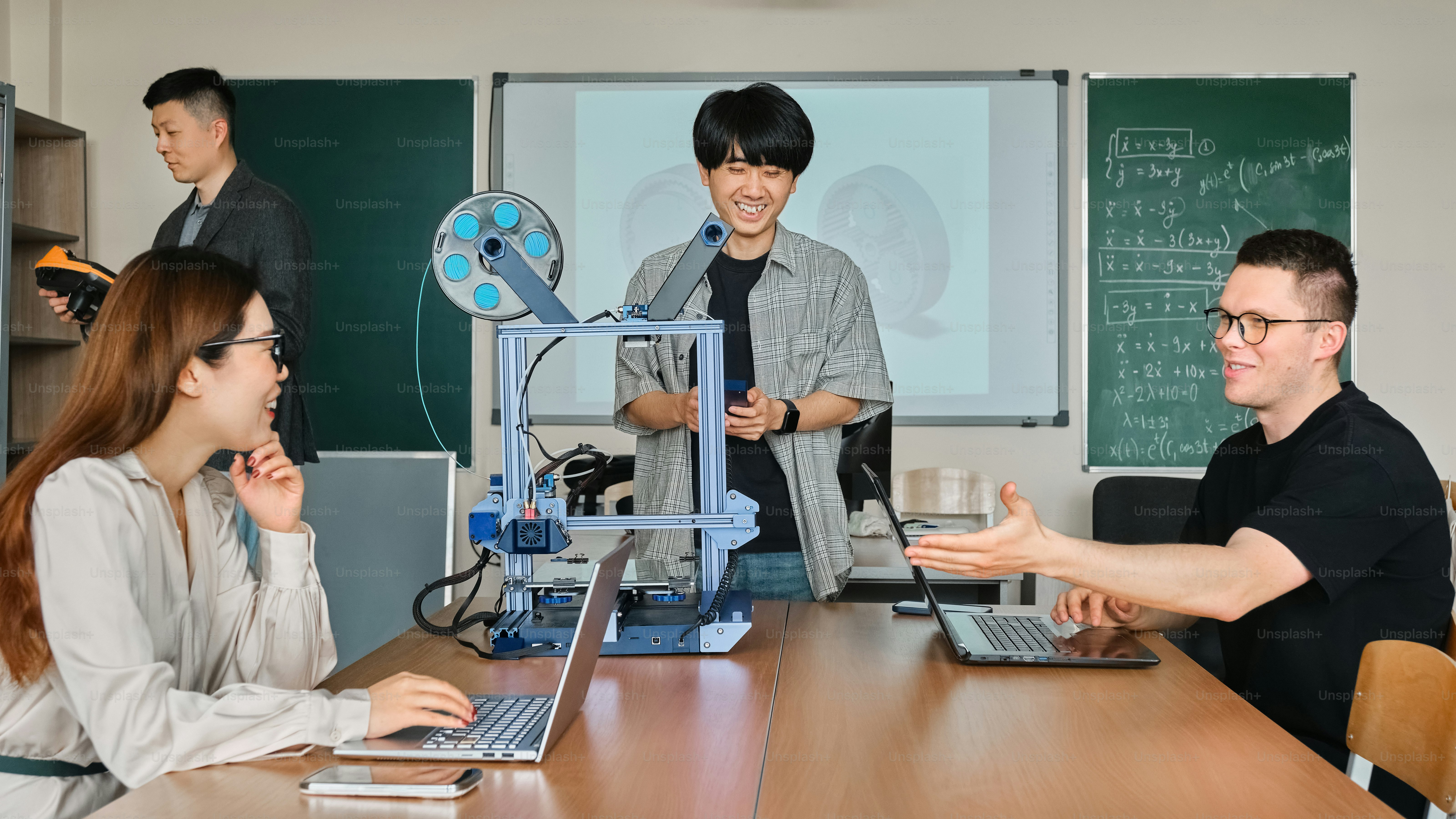 Designers, engineers, and technicians collaborating on 3D printing projects.