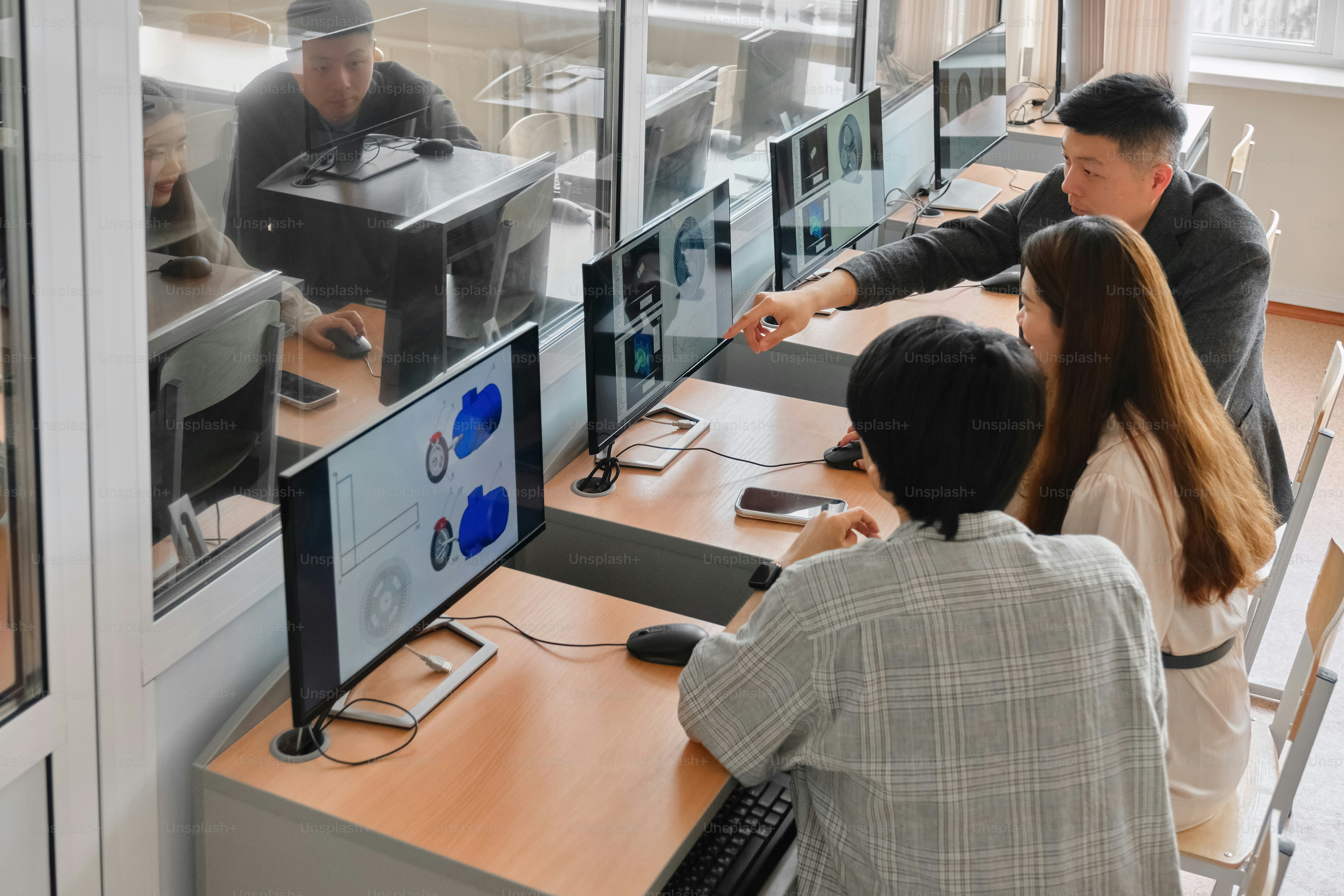 a man and a woman are looking at a computer screen