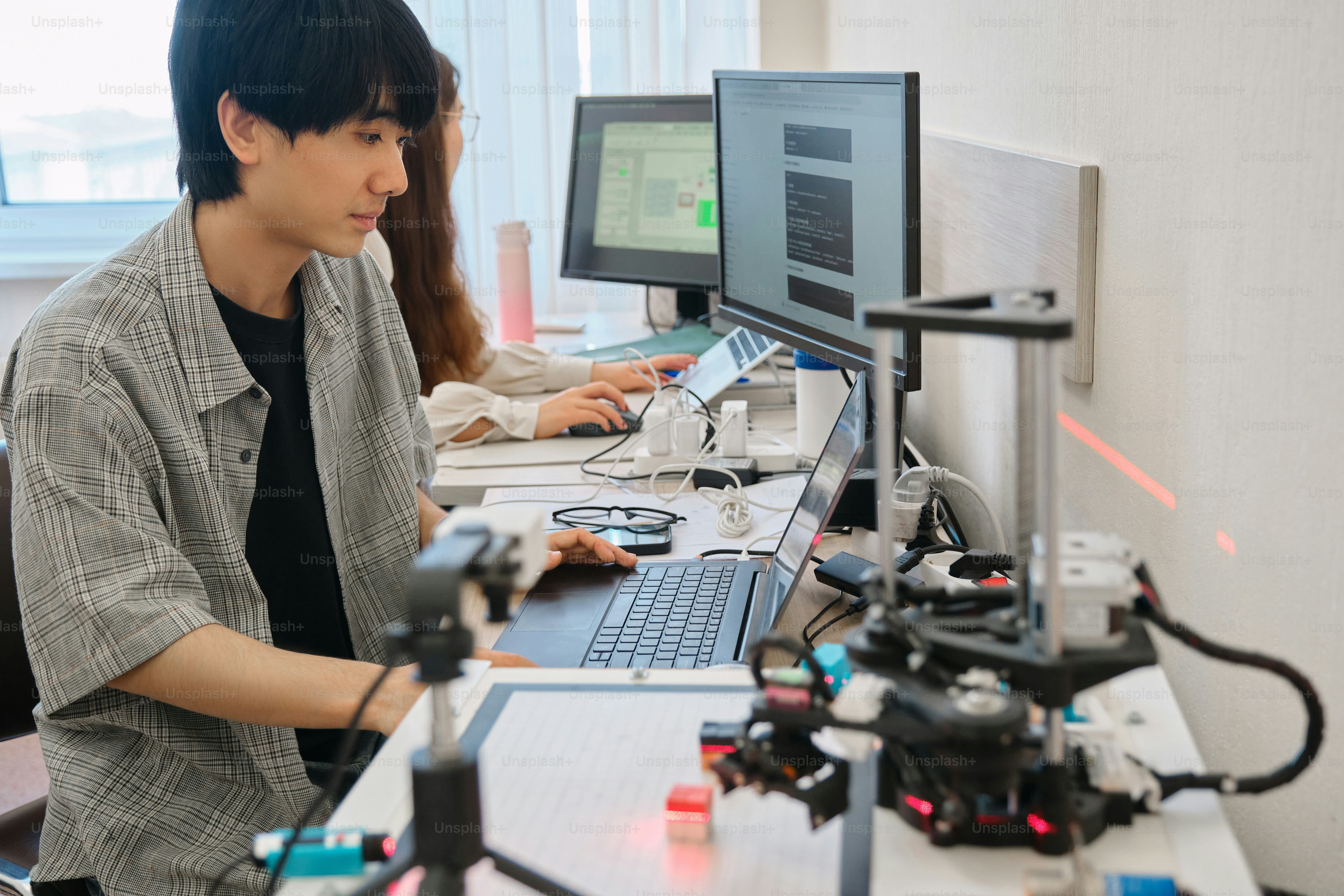 a man sitting in front of a laptop computer