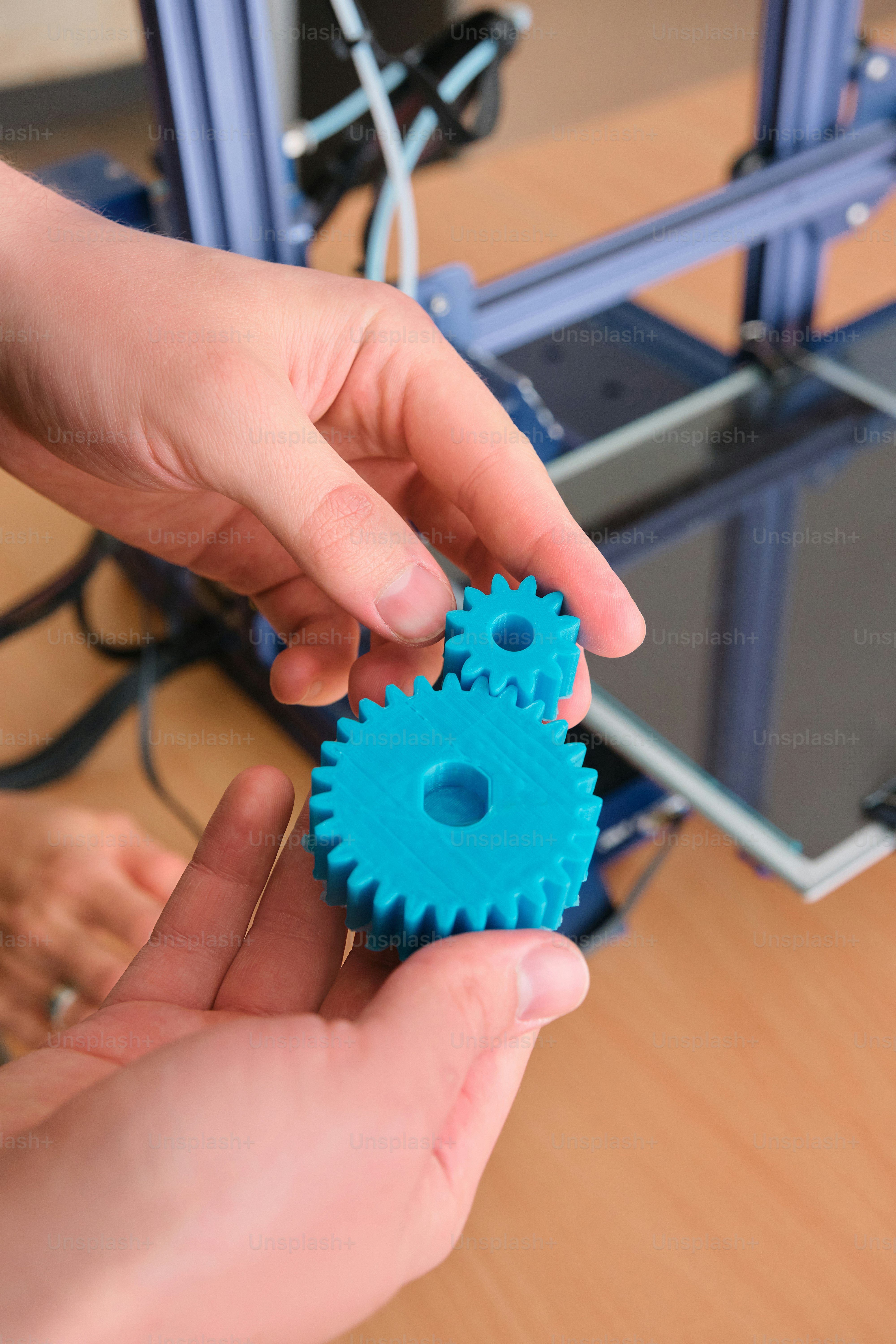 a person holding a blue gear in their hand