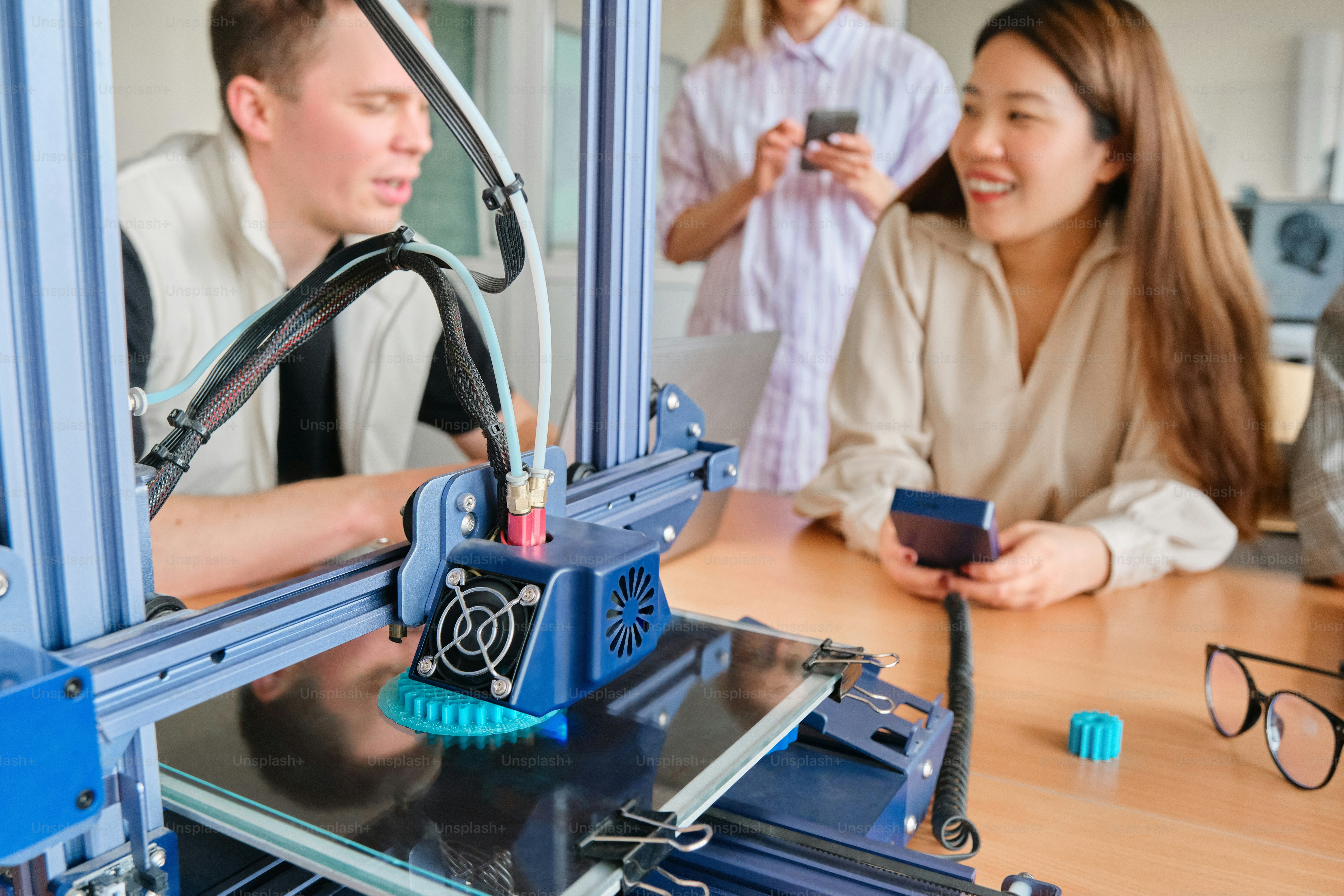 a group of people standing around a machine