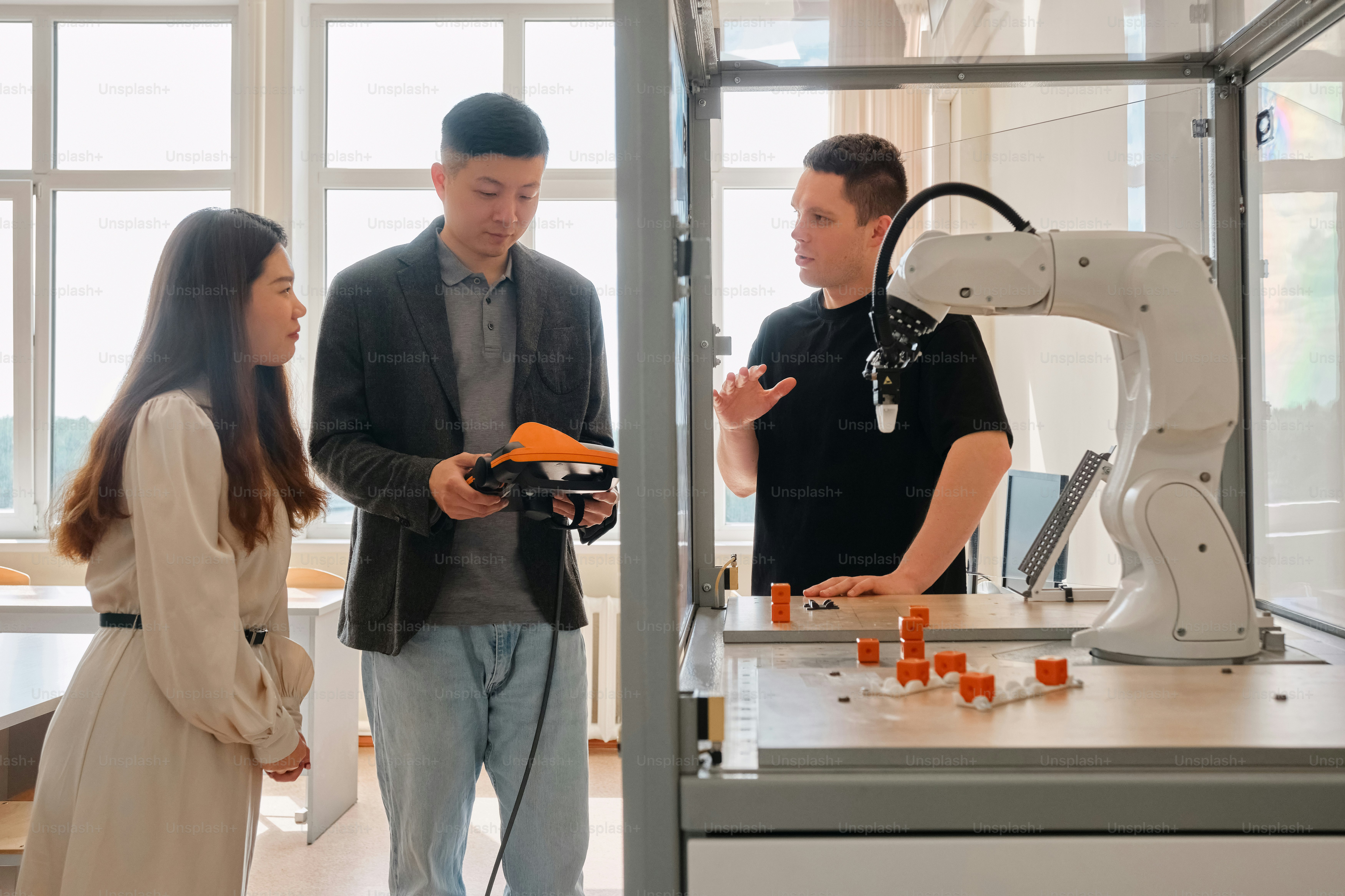 a man and a woman looking at a robot