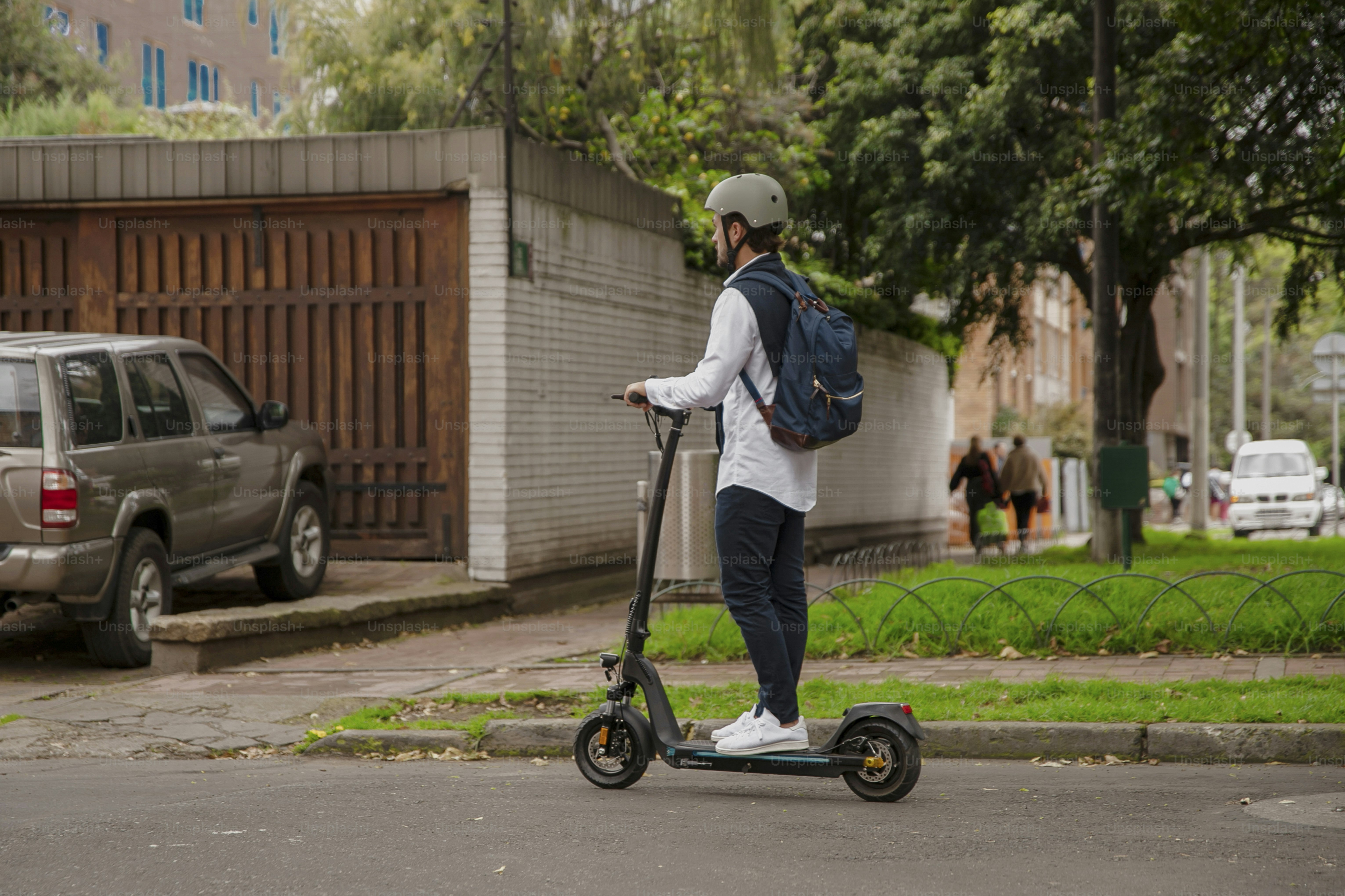 a person riding a scooter on a city street