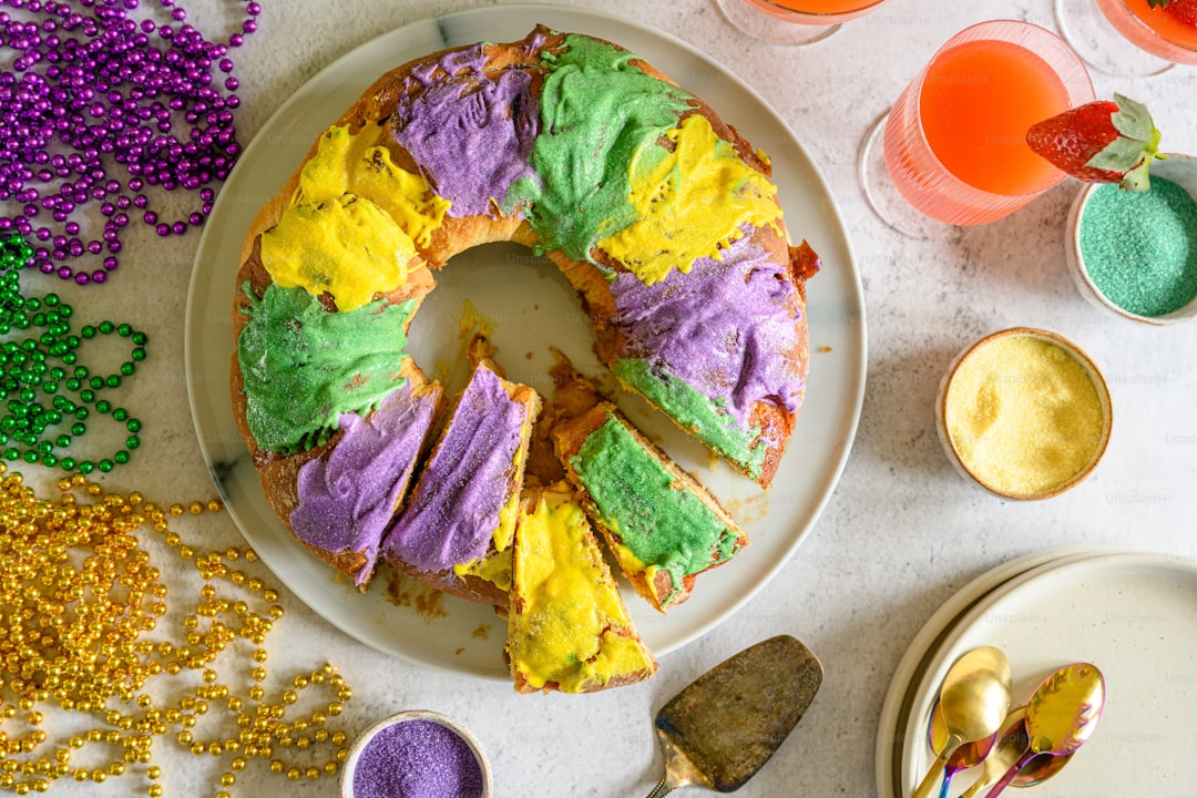 a white plate topped with a cake covered in purple and green frosting