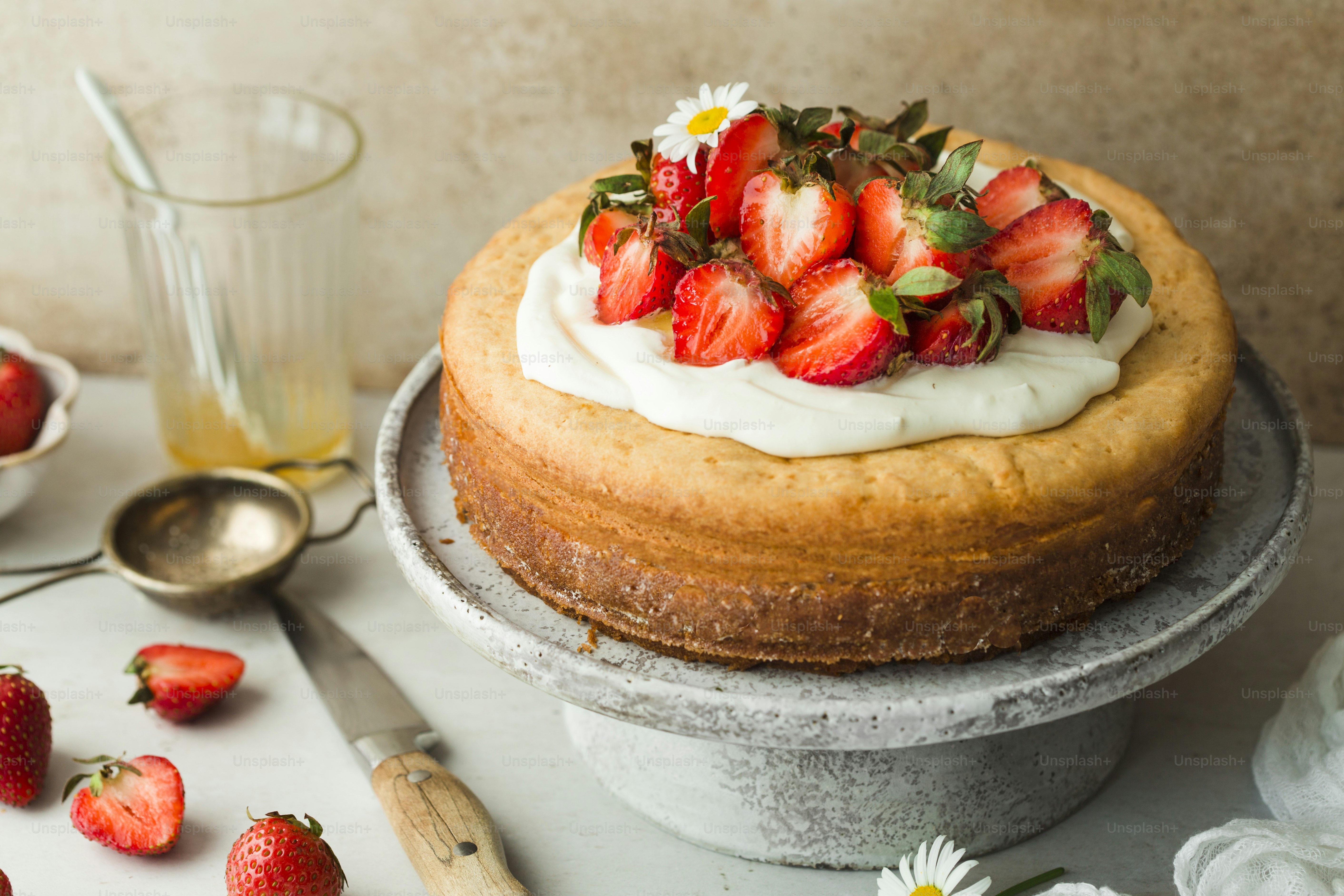 A cake with strawberries and whipped cream on top photo – Food Image on ...