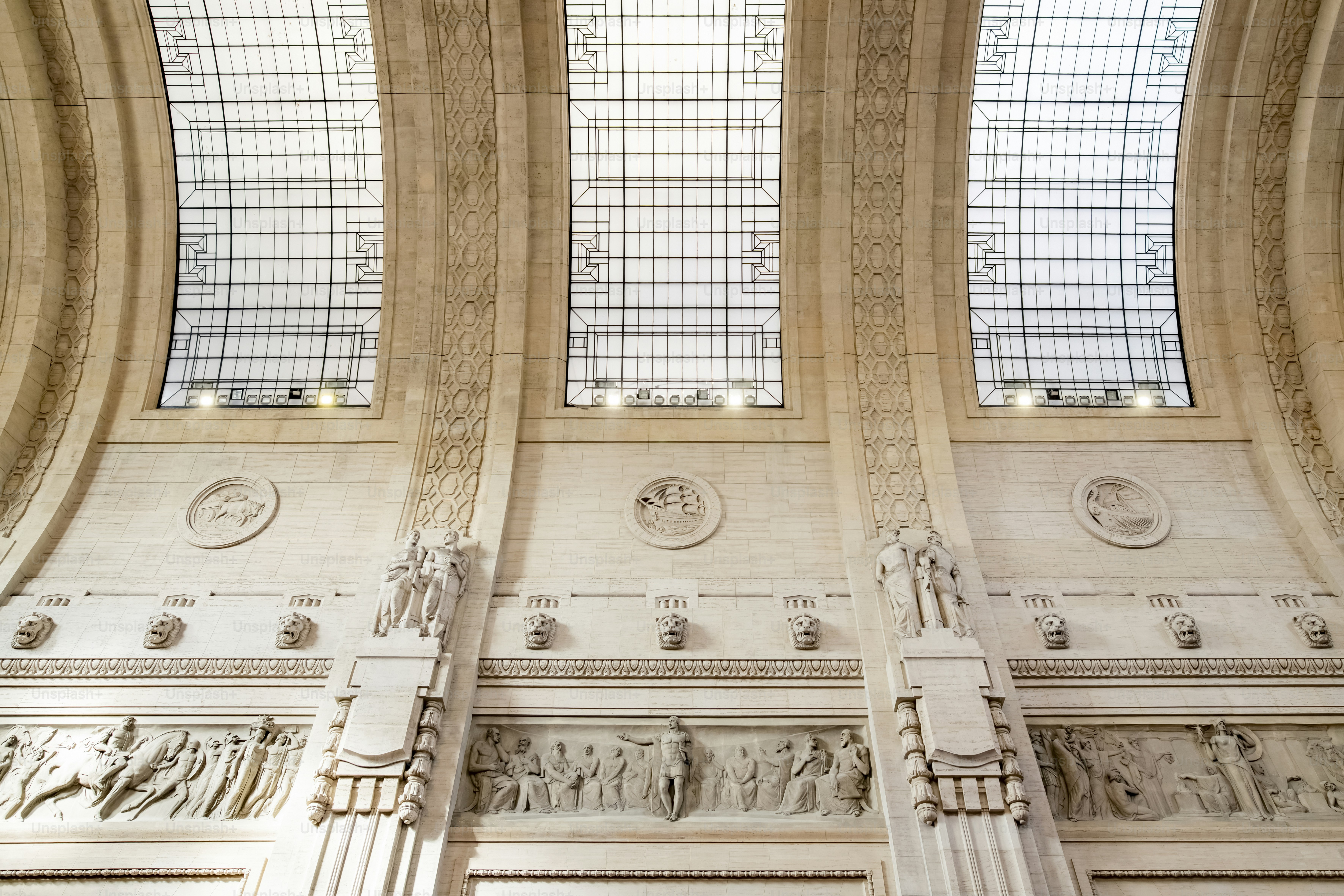 the ceiling of a large building with a clock on it