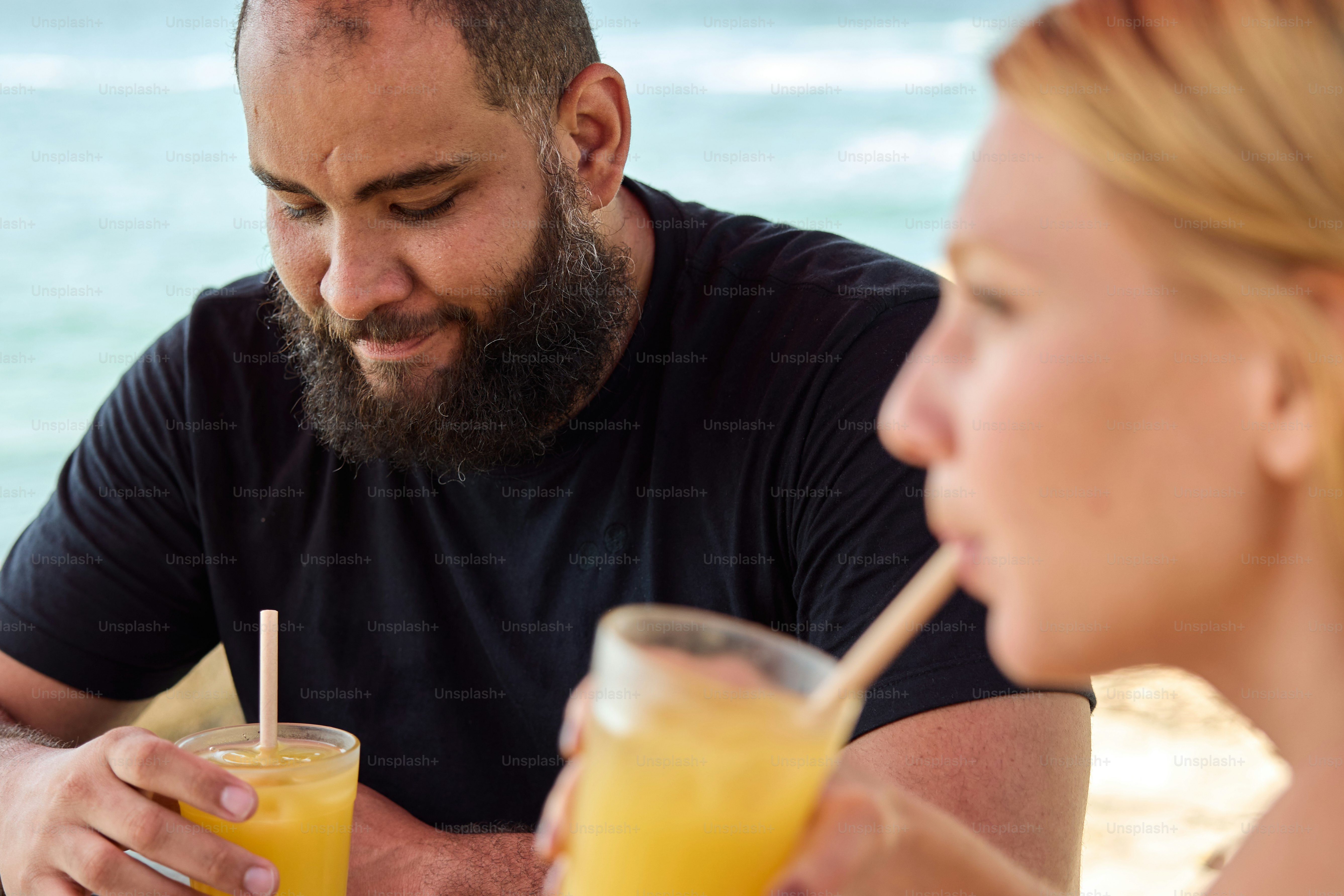 a man and a woman sitting at a table with drinks