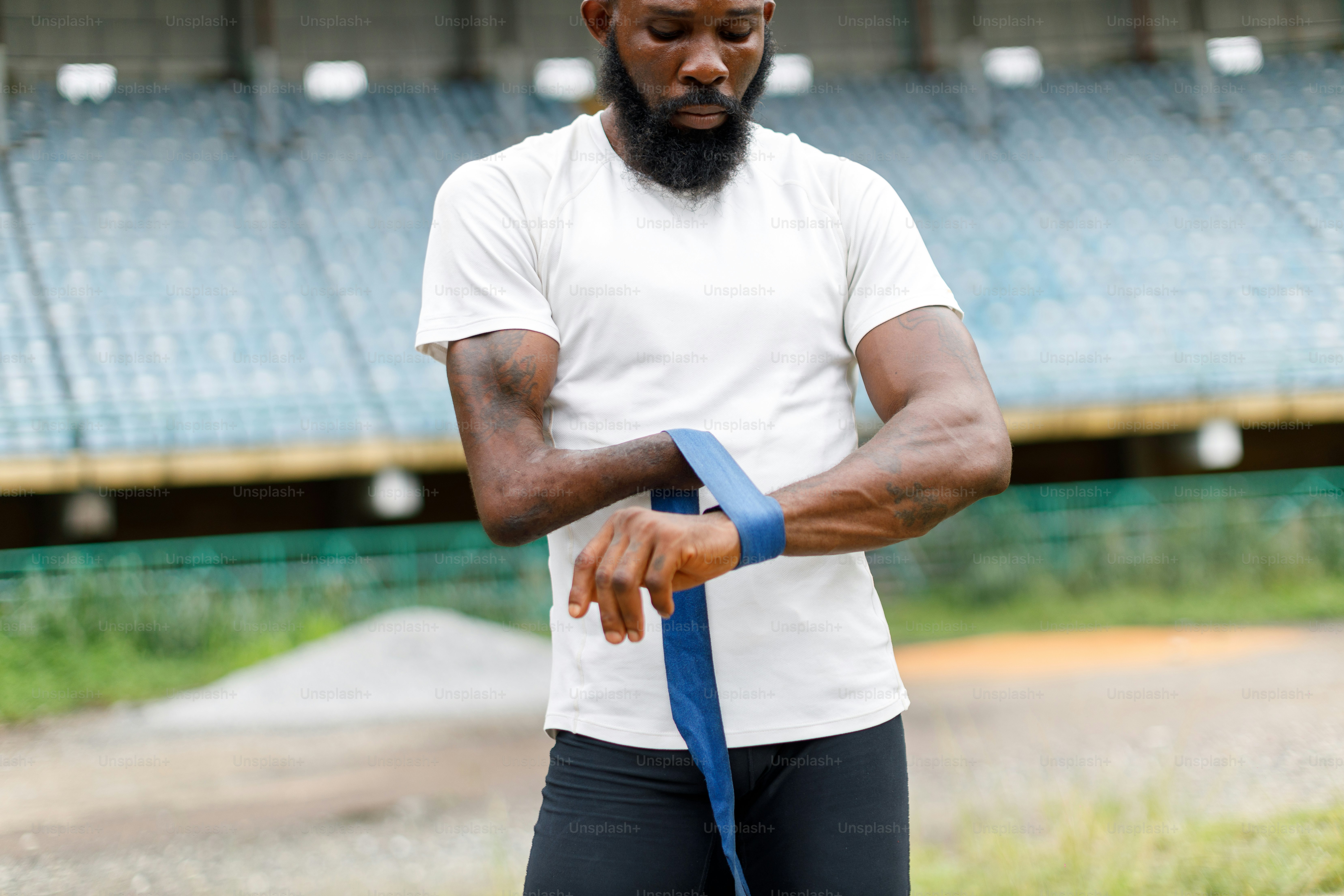 Ein Mann mit Bart bindet eine blaue Krawatte