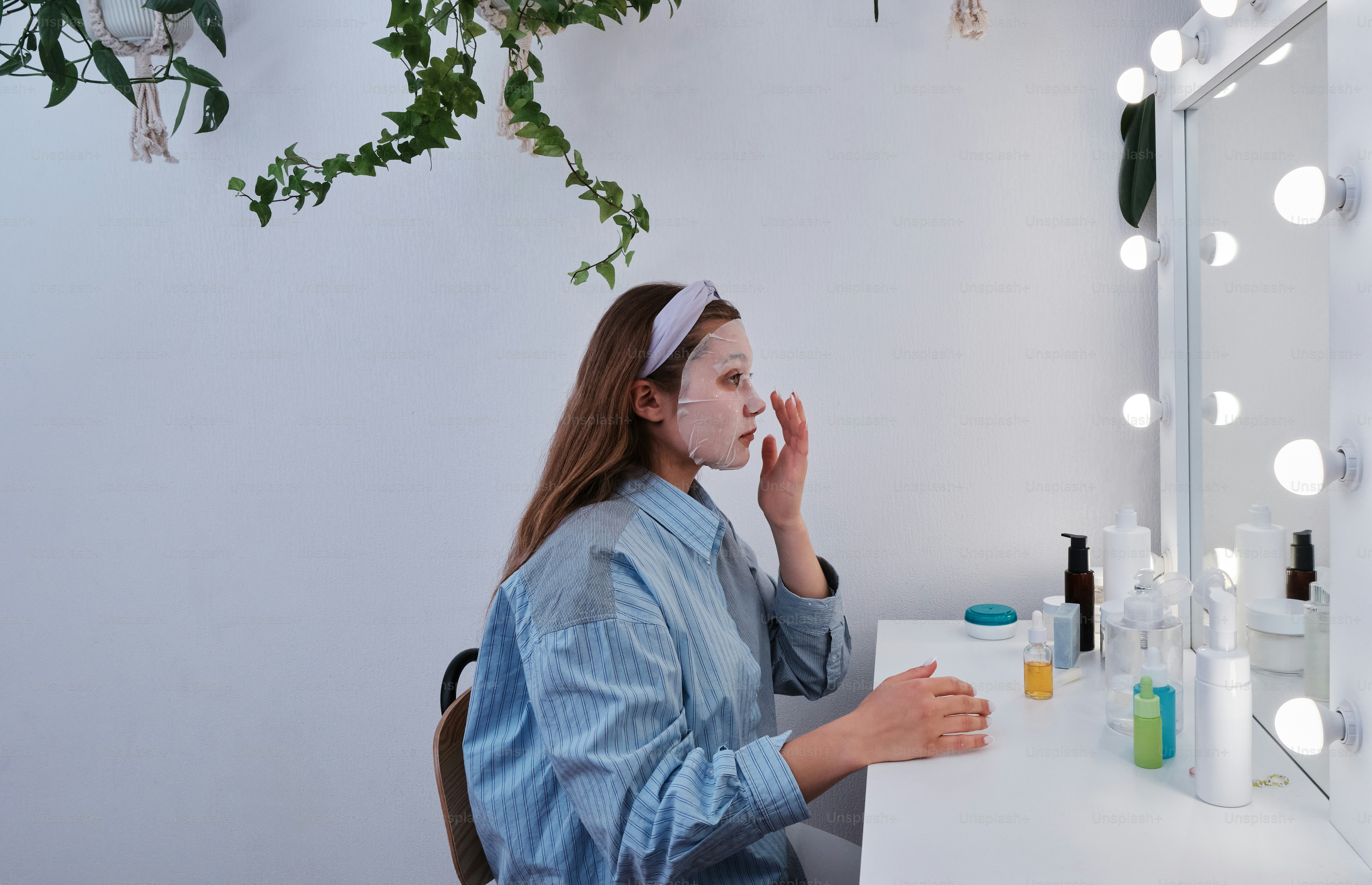 a woman sitting at a table in front of a mirror