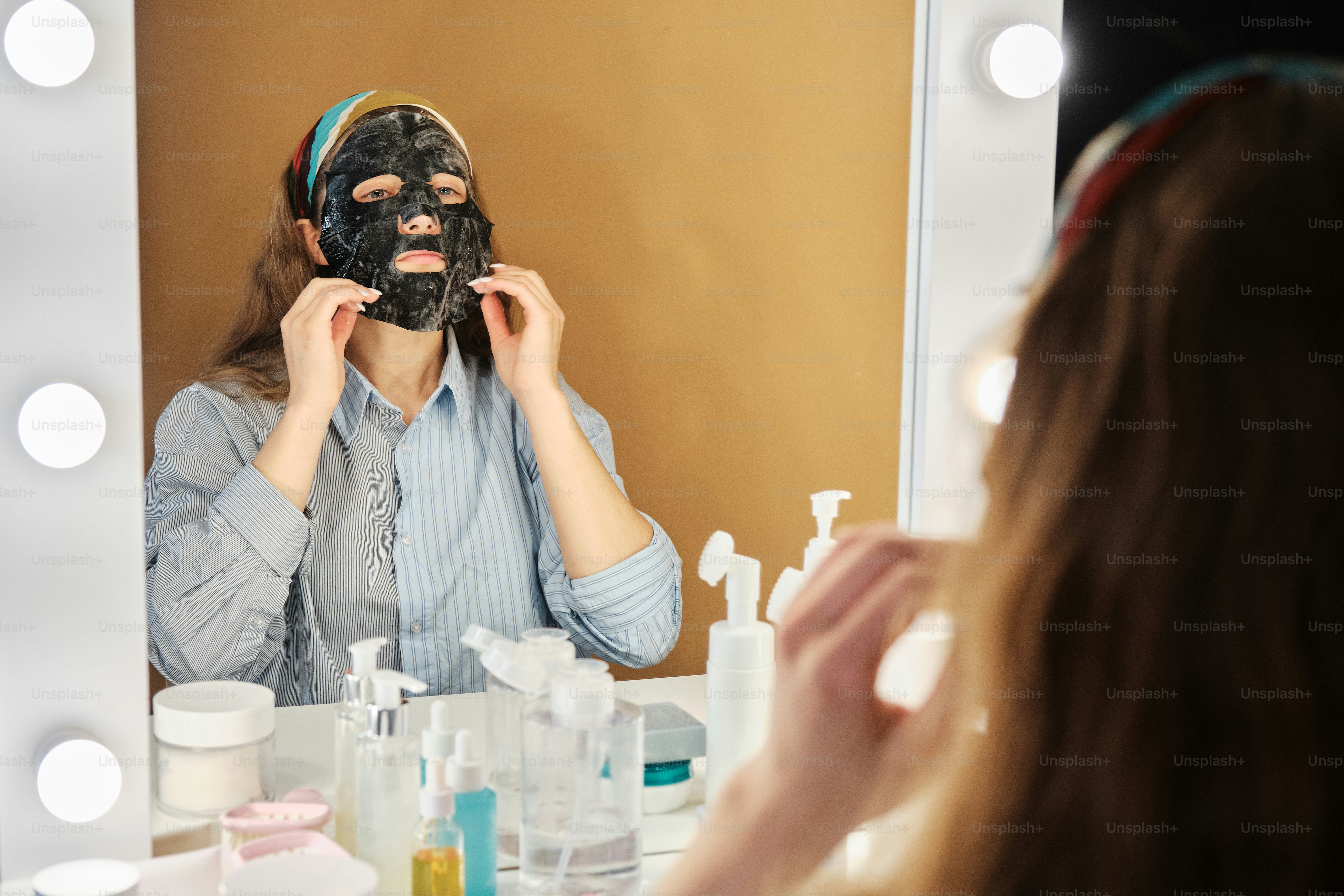 teen with sheet face charcoal mask