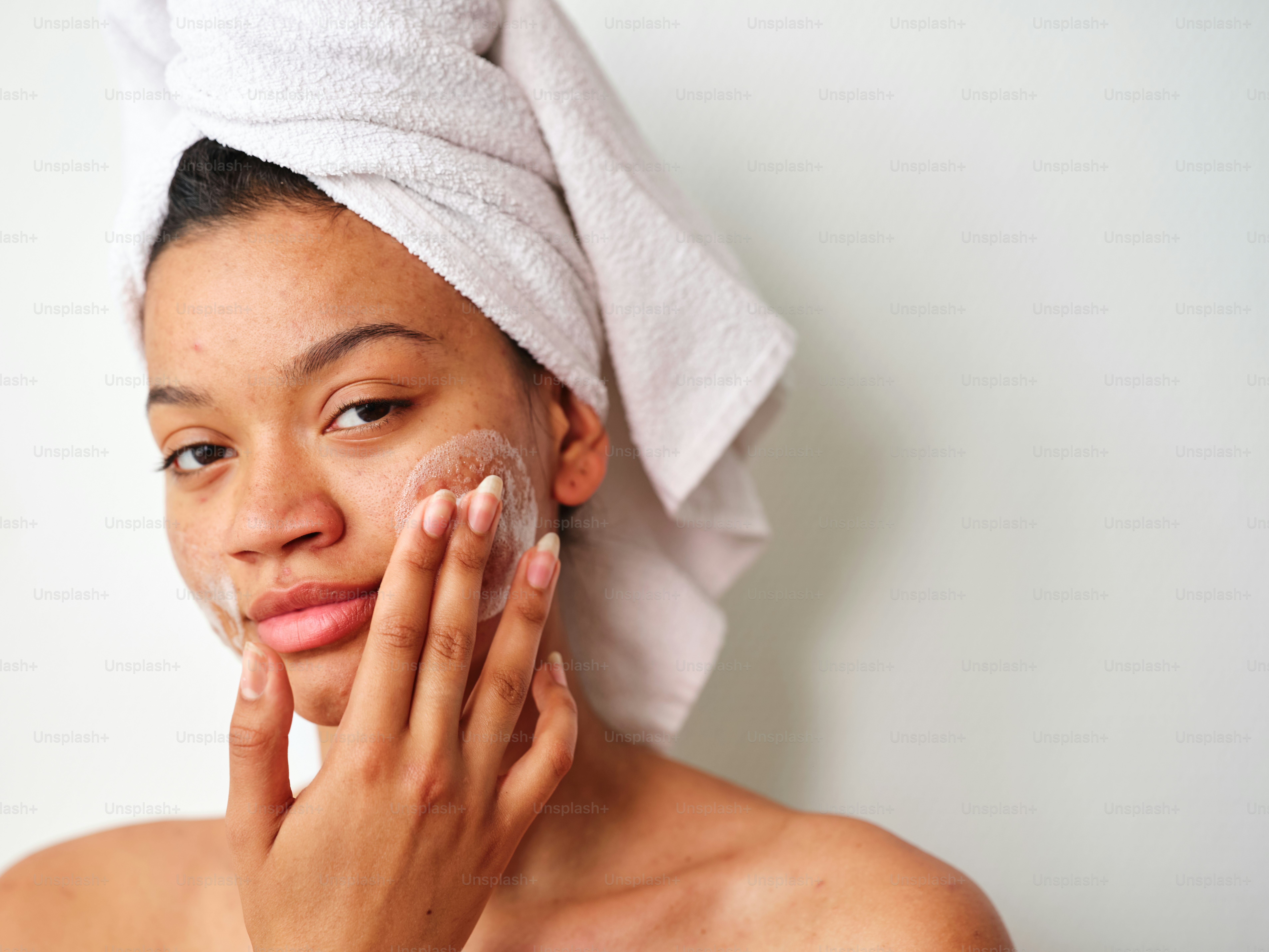 a woman with a towel on her head and a face mask on